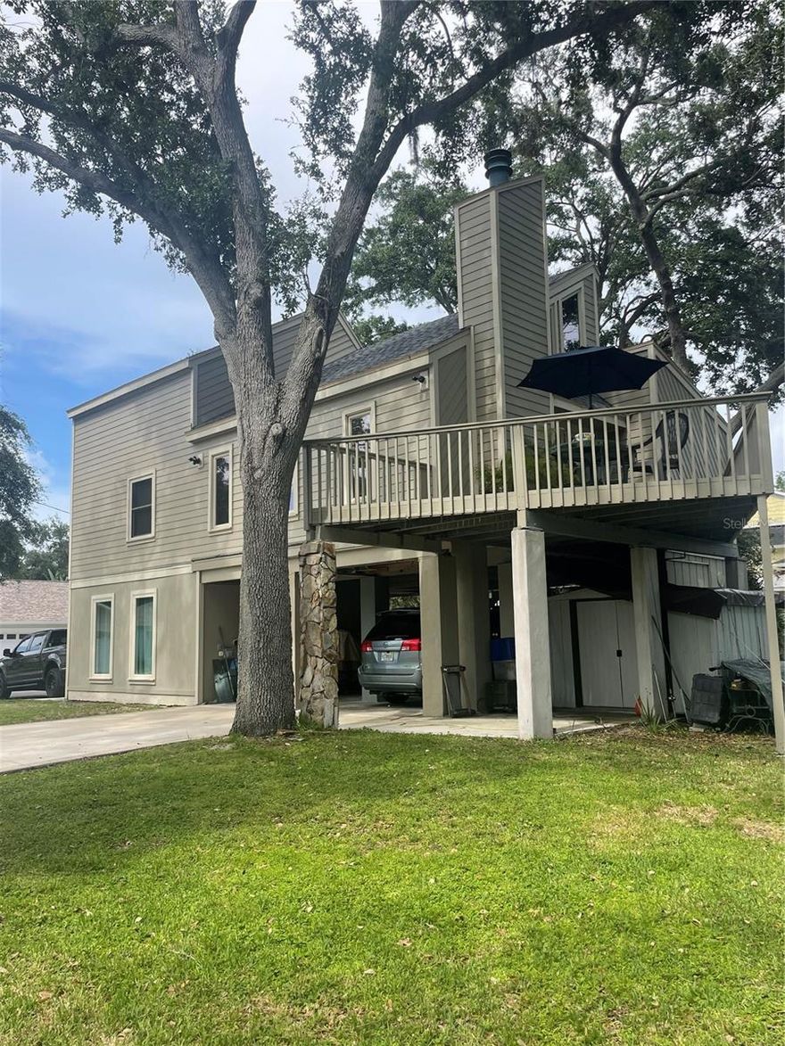 Location! Location! Highly desired Seminole neighborhood. Just minutes from beach, parks, grocery and pharmacies, highly rated public schools and Seminole City Center. Unique contemporary designed home nestled in the shade among a dozen established live oak trees on an oversized lot (1.5x) of average size lot on the street. Deep back yard open for multiple opportunities for your personal desires - custom
pool, pickleball court, animal exercise area, putting green - to name a few. Constructed of Hardee board siding and hurricane rated windows. New roof installed and exterior painted in 2022. Open floor plan with 3/4” oak hardwood floors in living and dining room area, newly installed carpet in 3 bedrooms. Post and beam construction. Wood burning fireplace with vents. Ceiling fans throughout. Gorgeous granite countertops and movable island made of solid maple. Propane stove, water heater (replaced 2022), and dryer resulting in lower utility costs, especially in summer. Lots of natural light. An indoor jacuzzi tub on the main floor. Exterior stairwell was rebuilt in 2022 along with renovated deck. There is 662 sq ft of covered area under the 10’ high stilts with space for parking 2 vehicles plus added available space. Concrete driveway was replaced and extended in 2021. 8’ x 10’ storage shed under the deck. The 4th bedroom/office has a Murphy desk/bed on the ground level and was newly finished in 2022 and has it’s own private full bath and exterior entrance. The private deck off the living room extends your enjoyment of being outdoors. You will also enjoy many beautiful sunsets from there.