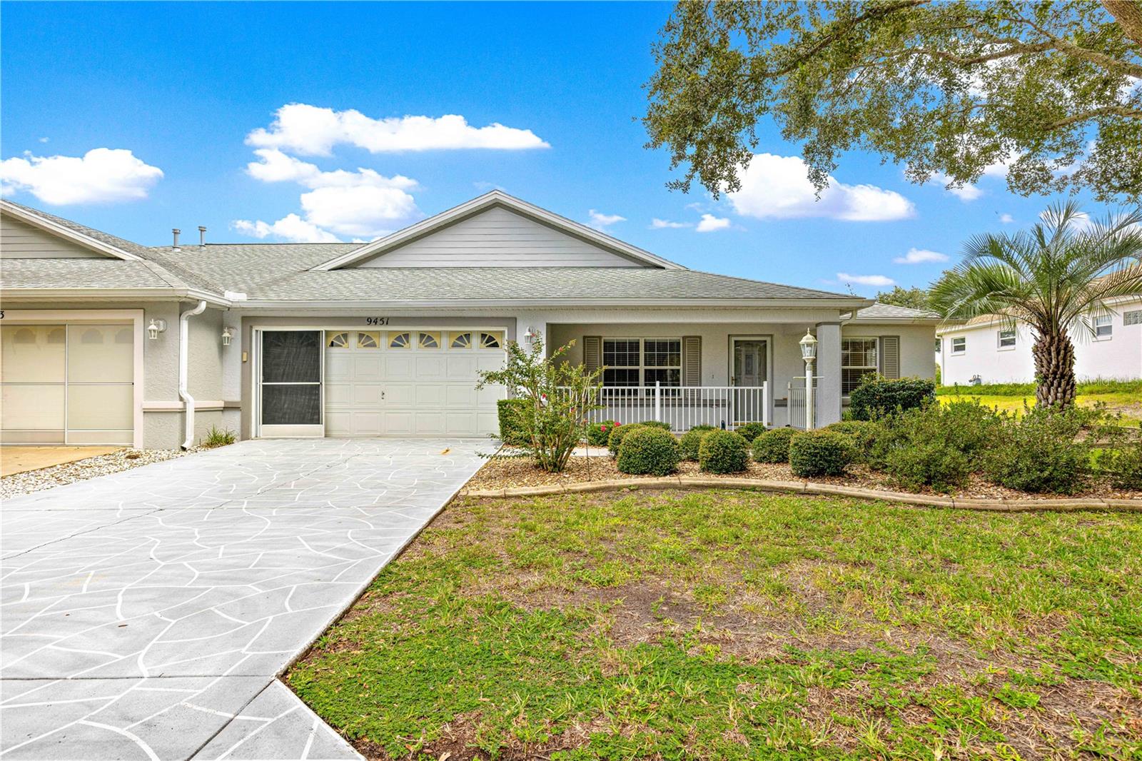 FLORIDA GOLF COURSE LIVING FOR UNDER $245,000!!!! Located directly on the 2nd Tee of “The Links” private golf course, this spacious Oakridge Model Duplex (1/2) located in the premiere 55+ gated golf community of On Top of the World in SW Ocala. Notice the Green Space in front of the home of this North-East facing home as you approach. Architectural shingle 30-year roof installed 2021, double pane windows, and natural gas appliances (range, dryer, water heater, furnace). Beautiful view from the large front porch – perfect spot to enjoy your morning coffee, or evening beverage! Step inside and immediately notice the HARDWOOD FLOORS and vaulted ceilings! Freshly painted throughout! To the right is the Flex/Den. Moving through Great Room to the Open Concept kitchen/family room (currently used as dining room). The large kitchen with prep island and family room are perfect for entertaining, adjacent to the finished Florida room and small patio for grilling – AND CHECK OUT THOSE GOLF COURSE VIEWS! Also included in the kitchen is a large pantry, smart lighting, brand new disposal, and solar tube for more natural light! The primary bedroom suite is in the back right of the home for privacy and MORE INCREDIBLE VIEWS. This bedroom has 2 WALK-IN closets, BRAND NEW UPGRADED 2-month old wall-to-wall carpet, and large en suite bath. The en suite has two separate vanities, step-in shower, and private water closet with comfort height toilet. The laundry closet is in the hall off the kitchen. The guest bedroom is in the back left of the home, also with brand new upgraded wall-to-wall carpet, and double closet. The hall/guest bath has tub w/tile surround. Entrance to the 2-car garage past the guest room with overhead storage and exhaust fan. All new window blinds throughout. The monthly HOA fee includes Basic Spectrum Cable, roof repair, exterior painting every seven years, exterior maintenance and insurance, landscaping, trash & recycling, 24/7 monitored gates and what seems like endless amenities; three pools (2 outside & 1 inside & another under construction), two state of the art fitness centers, pickleball (uncovered & covered), billiards, archery range, corn hole, bocce ball, tennis, shuffleboard, horse shoes, remote control flying field and race cars, 175+ clubs, woodworking shop (extra fee), library, and much, much more! A golf cart community with access to several shopping centers. Centrally located 20 minutes from the World Equestrian Center, easy drive to 4 cruise ports and/or airports, and within a close proximity to entertainment complexes in Orlando.