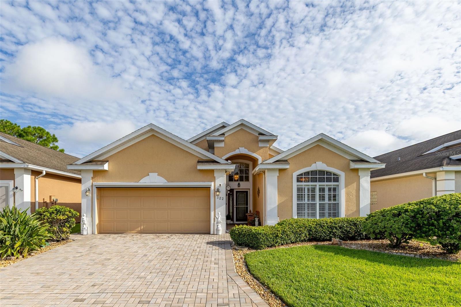 One or more photo(s) has been virtually staged. WELCOME TO THE PREMIER 55+ Golf community: Ridgewood Lakes in Davenport, Florida. This incredible Active Adult community is gated with a 24 hr guard and provides miles of extra wide walking trails throughout. Just a short walk to the High Vista Community pool and clubhouse to stay socially connected with friends and neighbors. Discover your sanctuary at this Gorgeous, well maintained Three bedroom/Two bathroom home. This home provides peace of mind and comfort where the original owner's pride shines through every detail. The high vaulted ceilings carries throughout the perfectly designed open layout to entertain guests in the combo: Dining Room and Great Room area. The spacious kitchen boasts sleek Quartz countertops along the counters, plenty of storage in the wood cabinets and pantry and built-in desk area to sit down to review your favorite recipes. Custom window shutters open up at the breakfast nook to fill the room with natural light and invites mornings filled with warmth and casual dining experiences. Enjoy the serenity of the enclosed lanai with windows that provides a tranquil space to relax while overlooking the pristine green space in the back. The Primary bedroom overlooks the backyard while into the En-suite the Primary bathroom features Quartz counters with dual sinks, walk-in shower with bench and grab bar, walk-in closet, storage closet and private toilet area. The secondary bedrooms are split at the front of the home shared by one full bathroom. You’ll love the convenience of an indoor laundry room with a secondary refrigerator and a two-car garage, complete with additional cabinet storage, fan and a drop down attic that answers all practical needs. The newly installed motorized garage screen is a thoughtful addition, to stay cool and pest free while working on projects in the garage. Plus, the home is pre-wired for a Generator hook-up on the left of the garage. Residents benefit from the HOA covering: lawn maintenance, Spectrum internet and cable and access to the clubhouse & community pool to allow for a worry-free lifestyle. High Vista has a resident owned clubhouse with ballroom and stage, library, card room, fitness center, arts & crafts area, planned activities and pub. Outdoors play shuffle board, bocce ball, tennis, pickleball or enjoy the large heated community pool and hot tub. Plus, this golf cart friendly community offers Golf cart paths leading the way down the main street to the 18 hole- White Heron Golf Club and restaurant. There’s multiple activity clubs to join to be as socially connected as you want to be. Located centrally between Orlando and Tampa just off I-4. Just across the street from Advent Health Hospital. Close to Orlando’s theme Parks to entertain your guests at: DISNEY World, Legoland, Sea World and Universal Studios. Just minutes to Posner Park which features restaurants and shopping galore.