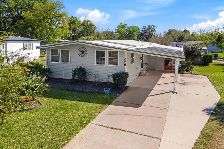 Why rent the land when you can own it? No HOA, no age restrictions, no limits! Stop the search—this is the affordable opportunity you’ve been waiting for! Welcome to a property that checks all the boxes: NO lot rent, you own the land, NO HOA, and NO age restrictions—giving you the freedom and flexibility so many buyers are looking for. Whether you’re searching for a full-time residence, a winter retreat to escape the cold, or a smart investment to add to your portfolio, this home delivers incredible value and versatility. From the moment you arrive, you’ll appreciate the convenience of the 2-car carport and extended driveway, offering plenty of parking for you and your guests. Step inside and you’re greeted by a spacious kitchen featuring abundant cabinet space, stainless steel appliances, and a stylish backsplash, making it both functional and inviting. The open flow between the living and dining areas, combined with numerous windows, creates a light, bright, and welcoming atmosphere perfect for everyday living or entertaining. The primary bedroom offers laminate wood flooring, dual closets, and a private en-suite bath with a shower, while the guest bathroom also features a convenient walk-in shower. Bedroom two includes a private exterior door, offering flexibility for guests, a home office, or even a separate entrance setup. Storage will never be an issue here—this property is packed with it! Enjoy a workshop with washer/dryer hookup, plus an additional shed/garage with roll-up doors—ideal for a golf cart, tools, or extra storage. On the opposite side of the home, you’ll find a fully fenced area perfect for pets, adding even more functionality to the space. Peace of mind comes with numerous updates, including a roof (2021), windows (2018), vinyl siding (2018), vinyl plank flooring (2018), A/C (2016), vapor barrier (2025), expanded concrete driveway (2019), and an addition completed in 2018—showcasing true pride of  ownership. For those seeking a sense of community, an optional social membership (55+) is available for just $400 yearly, offering access to a pool, shuffleboard, horseshoes, and a variety of social activities. And let’s talk about location—just minutes from Downtown Leesburg, shopping, dining, and The Villages, putting convenience and entertainment right at your fingertips.Affordable, versatile, and full of possibilities—this is more than a home, it’s an opportunity you don’t want to miss!