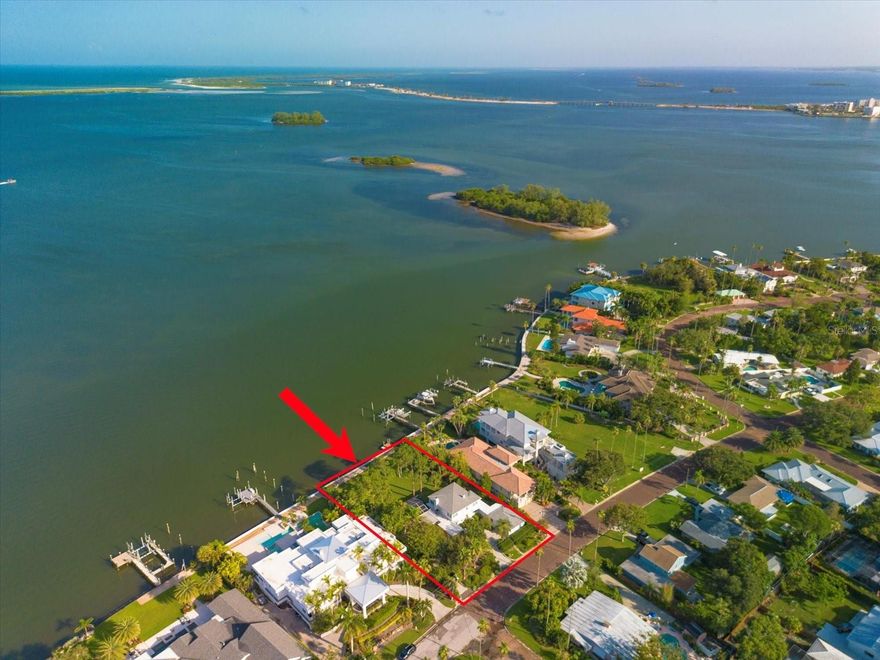 The Dunedin waterfront lot you dream about!  Panoramic views of St. Joseph Sound and the Intracoastal. Amazing double lot with 120 feet of new seawall.  Situated on the famous brick streets of Dunedin, lined with tall palms.  Good boating water, dazzling sunsets and visiting water birds.  The oversized lot is 119x199, which would generously accommodate a new build.  The current home is an example of iconic modern design found in the period from 1930-1960.  This school of architecture was meant for modern man and showcased simple lines and new materials like gleaming terrazzo, steel, reinforced concrete and glass.  Built-in's and storage were a big part of the design to keep the inside clean and simple.  This well-built home, with new hurricane windows, offers a primary suite on the first floor and 4 additional bedrooms (or 2 large suites with sitting areas) on the second level.  The house is exceptionally bright with large windows in every room.  A sun porch connects the house to an inviting screened-in pool.  The detached 2-car-garage has an adjoining laundry and hobby room/storage.   The observation dock is perfect for launching your kayak and the large lot is extremely private with mature landscaping on both sides.   All of Dunedin's amenities are at your doorstep!  Walk the Pinellas Trail, bike to the beach at Honeymoon Island, take a class at the Dunedin Fine Art Center or drive your golf cart downtown to shop and dine!  This one is very special!  Hurry!