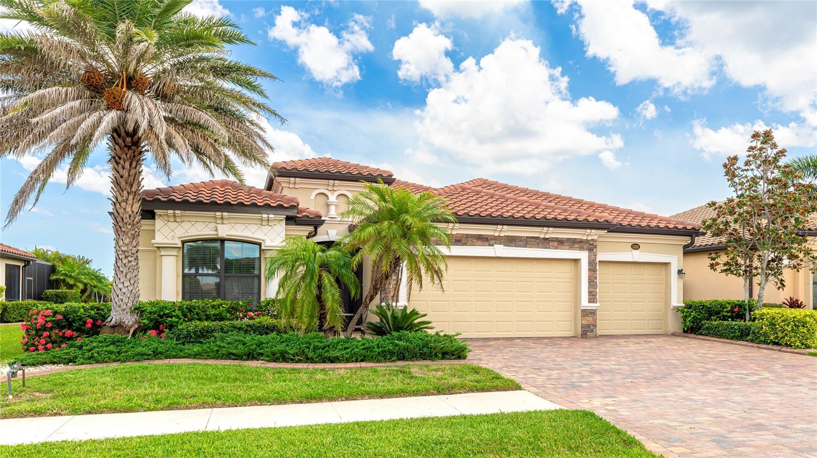 PRICED TO SELL. LOWEST PRICED 3 CAR GARAGE SINGLE FAMILY HOME IN WELLEN PARK. That’s not all. The CDD bonds balance is paid off, reducing the annual tax bill by approximately $1,423. Welcome to your dream home opportunity in the iconic Gran Paradiso community of Wellen Park, a Tuscan-inspired, resort-style gated neighborhood. This 4-bedroom, 2-bath, 3-car garage, single-family home is ready for you. Step inside to enjoy the open floor plan featuring elegant porcelain tile flooring, tray ceilings, crown molding, and ceiling fans throughout the main living areas. The gourmet kitchen, perfect for entertaining, boasts 42-inch wood cabinetry, granite countertops, stainless steel appliances, a breakfast bar, and a cozy eat-in dining area. A luxurious master suite offers a large walk-in closet, private lanai access, and a spa-like en-suite with dual sinks, a soaking tub, separate walk-in shower, and granite countertops. The versatile 4th bedroom is ideal as a home office, den, or guest room. The 3-car garage is equipped with overhead storage, additional shelving, a 2022-installed Mini Split A/C unit to keep garage contents cool and expand what can be stored in the garage, and a 50-amp service box with an included generator capable of powering essential home systems, including the A/C, during outages with proper load management. The outdoor features elevate this home’s appeal: enjoy a private lanai with an included above-ground spa, new roll-down hurricane shutters (manual for windows, electric for lanai) and shutters on all windows for storm protection, and low-maintenance river rock landscaping replacing mulch. Stylish rustic barn doors adorn the master suite and guest room entrances. Additional conveniences include an in-wall pest control system, a laundry room with a deep sink and storage cabinets. Gran Paradiso’s deed-restricted community with on-site management offers world-class amenities, including a resort-style pool, spa, fitness center, sauna, steam room, pickleball, tennis, basketball courts, playgrounds, library, craft rooms, billiards, aerobics room, and a vibrant social calendar with year-round events. Cable, internet, and lawn mowing are included. Located just 10 minutes from 11 breathtaking Gulf beaches, the Atlanta Braves Spring Training Stadium, top-rated golf courses, dining, shopping, and world-class fishing, with easy access to Venice, Punta Gorda, and Sarasota, this move-in-ready home is a rare opportunity at an unbeatable price. The seller is highly motivated—schedule your private tour today! Furniture is available for separate purchase.