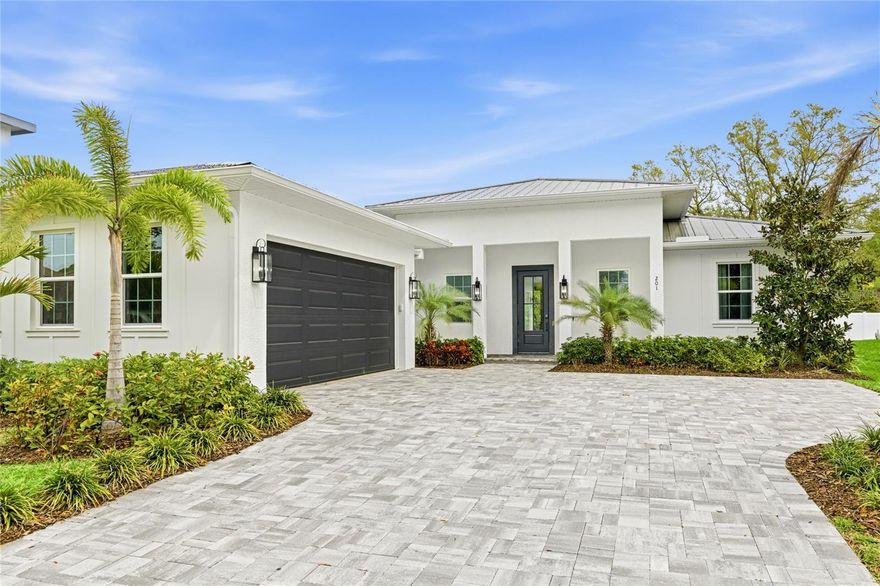 Welcome to this exceptional ONE-STORY, NEWER CONSTRUCTION, 3 Bedroom, 3 Bath PLUS Office/4th Bedroom home featuring a Saltwater Pool, Lanai, Outdoor Kitchen and oversized 2 Car Garage. Offering over 2500 square feet of luxurious living space, this home is perfect for entertaining and enjoying the ultimate Florida lifestyle. Located in FLOOD ZONE X and just minutes to Downtown Sarasota, this custom-built home boasts all BLOCK construction, a metal roof, maintenance-free aluminum soffits and fascia, Impact Rated Windows, Doors and Sliders, a tankless gas water heater and a professionally designed custom landscaping package. Interior features have been thoughtfully designed and include 12 ft 8-inch ceilings in the Great Room and Kitchen, 8 ft solid core doors and engineered hardwood floors throughout the home. The well-appointed kitchen is sure to please the most discerning chef with custom wood Shaker Cabinets, an oversized island, Quartz countertops, Z-Line Appliances, double oven, an induction range with custom hood and includes a convenient Dry Bar with floating wood-stained shelves and a wine refrigerator. The Primary Suite is a sanctuary and exudes elegance with tray ceilings, a custom design wall featuring detailed trim work and sliding glass doors providing private access to the outdoor pool and patio oasis. Primary Bath delights with a freestanding soaking tub, an oversized shower with rain head, a makeup vanity and Quartz countertops. Entertain with style in the Great Room complete with fireplace, 50-inch oversized chandelier and wall to wall 8 ft pocketing sliding glass doors opening to the Lanai and Saltwater Pool. 3 additional bedrooms, one featuring a decorative custom accent wall perfect for an office/flex room, are all generously sized with built-in closets. The Laundry Room includes a custom tile floor, built-in cabinets, Quartz countertops and a Samsung Smart washer and dryer. Easy access to Downtown, the Legacy Trail, Payne Park, Sarasota Memorial Hospital, Siesta Key and all area beaches makes this Move-In Ready home a must see! Embrace Sarasota living at its finest!