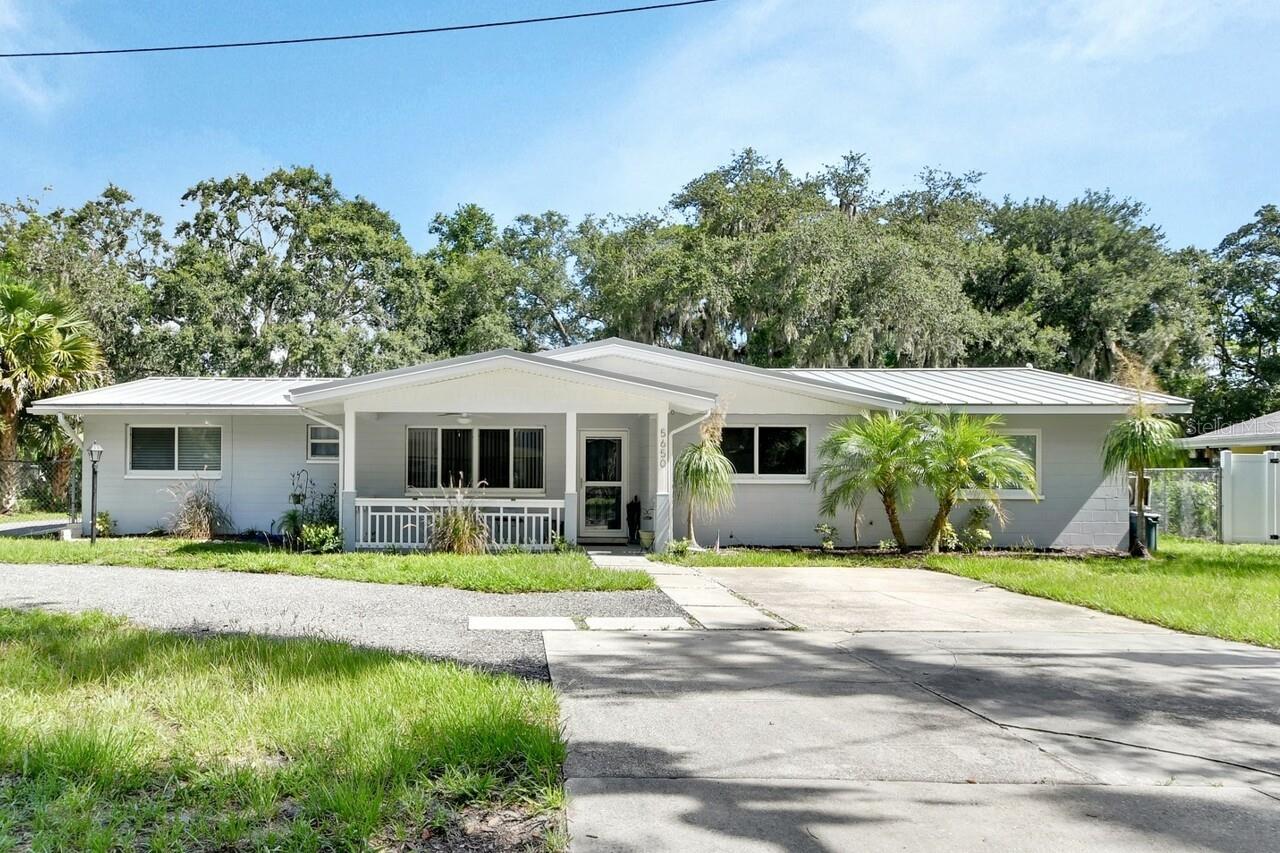 Fully Renovated 4-Bedroom Ranch on Nearly Half an Acre in Port Orange! With NO HOA!
This beautifully renovated 4-bedroom, 2-bath ranch-style home sits on nearly a half-acre lot in Port Orange. From the moment you walk up to the front porch and through the front door, you will appreciate the open and split floor plan, flooded with natural light from a large picture window that welcomes you into the living space.
The stunning kitchen is fully updated with an island, stainless steel appliances, and a dining area that is perfect for hosting and entertaining. Two spacious guest bedrooms are located on one side of the home and share a fully renovated bathroom with modern finishes.
Prepare to be amazed by the luxurious primary suite, which features a gorgeous tray ceiling, an oversized custom walk-in closet, and a spa-like primary bathroom complete with a walk-in shower, garden tub, dual vanities, and a brand-new mini-split for personalized comfort.
A fourth bedroom—perfect as a nursery, home office, or small guest room— conveniently located just off the primary suite.
Step out through the French doors onto a spacious screened lanai overlooking a large, beautifully shaded backyard. Entertain with ease at your outdoor summer kitchen and enjoy the benefits of a 12’ x 30’ shed—ideal for a workshop, studio, or extra storage.
Upgrades include: Brand-new metal roof, 2 solar attic fans, updated electrical system, new luxury vinyl plank flooring throughout, fresh interior and exterior paint, new driveway, Tankless hot water heater.
Located just off Nova Road near Dunlawton Avenue, you are close to shopping, dining, beaches, and Daytona International Airport.