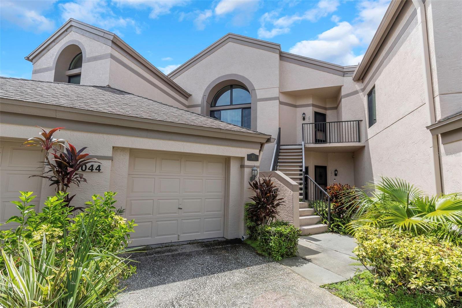 Beautiful turn-key, recently updated 3-bedroom, 2-bathroom condo in the Oaks at Countryside community. Private, deep 1-car garage with plenty of storage space and shelving. Recent upgrades include new waterproof vinyl floors, light fixtures, bathroom vanities, tile showers, butcher block countertops, and newer hot water heater, AC unit, roof, and stainless steel appliances. Spacious primary bedroom with walk-in closet and private en-suite bathroom. End unit with extra windows. Washer/dryer hook-up in the condo. First-floor unit for ease of access. Screened in back patio/lanai with a hurricane shutter for extra protection. Condo is a short distance to the pool, heated spa, tennis court, and clubhouse with full kitchen perfect for entertaining guests. Up to 2 pets are allowed with board approval. Close to restaurants and shopping. Water is included in the monthly condo fee. No pending or upcoming special assessments. Condo building is only 2 stories total, so the community is exempt from a Milestone Inspection Report and Structural Integrity Reserve Study which should help keep condo fees lower.