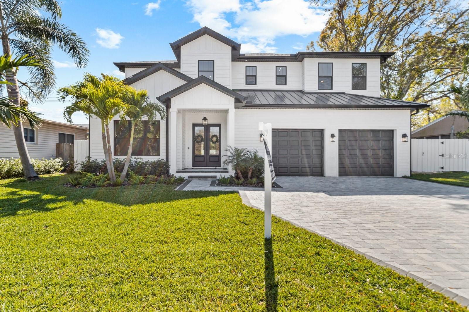 New Construction Home - Recently Completed! This beautiful traditional custom farm house design by Harlaxton Homes in the renowned Bayshore Beautiful South Tampa neighborhood has ample living space including a grand foyer, office, large kitchen, family room with a gas fireplace, living room, mud room, upstairs laundry room, and 5 bedrooms and 5 and a half baths, with an oversized two car garage and an upstairs bonus room. Unique features of this property include Hardie siding, high end engineered oak floors throughout, wainscoting, wet bar, custom cabinetry, high-end Monogram appliances with a gas cook-top, built-in breakfast nook and mudroom storage areas, crown molding throughout home, a dog bath and two downstairs bedrooms. This property exudes an indoor/outdoor lifestyle with lots of natural light and large pocket doors in the kitchen that lead to an outdoor lanai featuring a built-in grill entertainment area. The house has Brazilian marble and quartz countertops, including a Primary Room en suite bath with Brazilian marble walls, counters and floors, a free-standing tub, rain head shower, and walk-in closets. A 10K allowance will be given to customize the closets. The property is centrally located – only a 5 minute walk to Bayshore Blvd., 5 minute drive to Hyde Park Village, 10 minute drive to Downtown Tampa, and extremely easy access to Selmon Expressway. The home is located in Roosevelt, Coleman and Plant school districts. Tour the home here: http://www.viewshoot.com/tour/MLS/3148WestEuclidAvenue_Tampa_FL_33629_1015_308344.html#tour-1