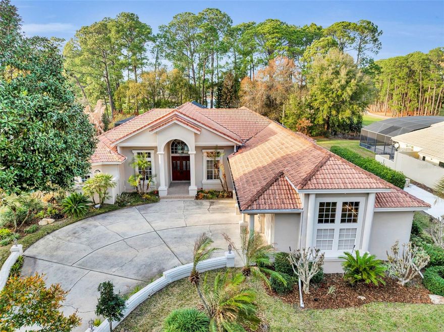 Nestled within the serene enclave of Signature Cove in the sought-after Timacuan Golf Course community, this renovated 5-bedroom, 4-bath residence offers refined Florida living on a generous .39-acre cul-de-sac lot. Built in 1990 and thoughtfully updated in 2018, this expansive one-story home spans 3,526 square feet and showcases sweeping views of the pool, pond and the 2nd hole from the moment you step inside. Light-filled and designed for both entertaining and everyday comfort, the split floor plan features elegant marble and wood flooring throughout. The heart of the home is the stunning kitchen, complete with granite countertops, stainless steel appliances, double ovens, a breakfast bar, and seamless flow into the spacious family room. A cozy fireplace and dry bar enhance the home’s inviting atmosphere. Formal living and dining rooms offer picturesque views of the pool, golf course, and surrounding wildlife, creating a peaceful backdrop for gatherings. All bedrooms feature walk-in closets, while the spacious primary retreat includes a private alcove ideal for a home office, fitness space, or quiet sitting area with tranquil views. The fifth bedroom includes built-ins and functions beautifully as a dedicated office or flex space. Step outside to enjoy the sparkling screened pool and expansive outdoor setting, perfectly positioned to capture golf course vistas. A 3-car garage provides abundant storage and room for a golf cart. Conveniently located near shopping, dining, and major roadways including I-4, 417, and 429, this exceptional Lake Mary home combines privacy, luxury, and accessibility in one of the area’s most desirable communities.