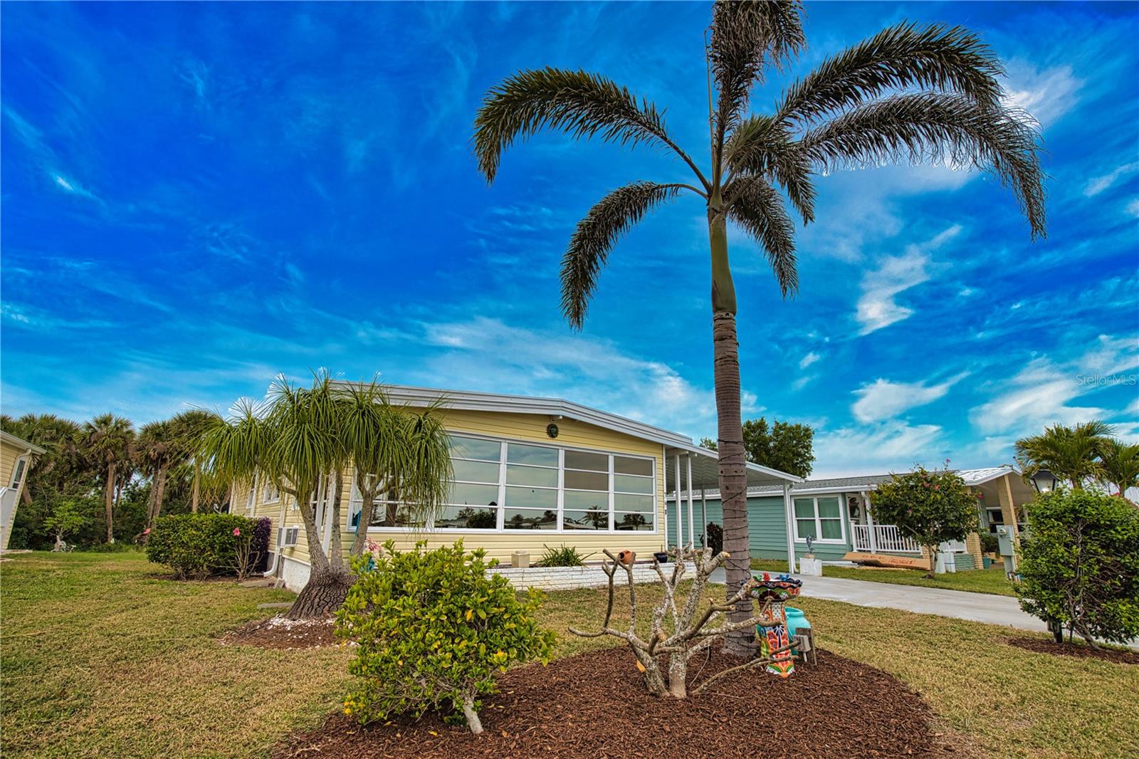 Unveil your Florida dream home! This enchanting property is perfectly positioned, offering breathtaking views of a serene lake in the front and a lush backdrop of the Myakka, ensuring your backyard remains an untouched oasis of greenspace. Imagine savoring these picturesque views from the expansive oversized lanai, a perfect haven for relaxation and entertainment. Step inside to discover a thoughtfully designed open concept that beckons gatherings with friends and family. The gourmet kitchen is a chef's delight, showcasing a large breakfast bar, elegant granite countertops, and exquisite solid wood cabinets. Unique touches, including a propane stove and an under-sink water heater, elevate the home's allure. The under-air Florida room invites you to indulge in tranquil mornings with a cup of coffee or unwind with an evening beverage, all while enjoying the stunning lake views. Your primary bedroom will be a personal sanctuary, featuring sliding doors that lead to the serene greenspace of the backyard. The ensuite bathroom is a luxurious retreat, complete with a spacious walk-in closet, double sinks, and a beautifully tiled walk-in shower. Your guests will adore the second bedroom, where comfort awaits in a cozy setting with its own walk-in closet Just across the hall, the guest bath features a stylish tiled floor and an updated tub/shower combination that exudes charm. Many upgrades including a new membrane roof in 2024, vapor barrier, a new ceiling in the Florida room, a new carport, and new vinyl siding all in 2025. Don't let this one-of-a-kind gem slip away--seize the opportunity to make it your own! Discover the enchanting community of La Casa, where 974 homesites are elegantly nestled among a tapestry of native trees, offering a serene escape surrounded by spacious common areas and eight picturesque lakes. Our generous lots average an impressive 60 by 80, providing ample space for your dream home. Conveniently located between Sarasota and Fort Myers, La Casa embodies the ultimate lifestyle on Florida's Gulf Coast. Enjoy the convenience of nearby shopping, exciting sightseeing, world-class golfing, and abundant fishing and boating opportunities. Our community is adorned with lush landscaping that reflects the loving care both management and residents dedicate to preserving the beauty of La Casa. Wireless (Wi-FI) is available at the Clubhouse, Activity Building and Recreation Hall. La Casa has it all. La Casa is not just a community; it's a welcoming family-friendly haven.