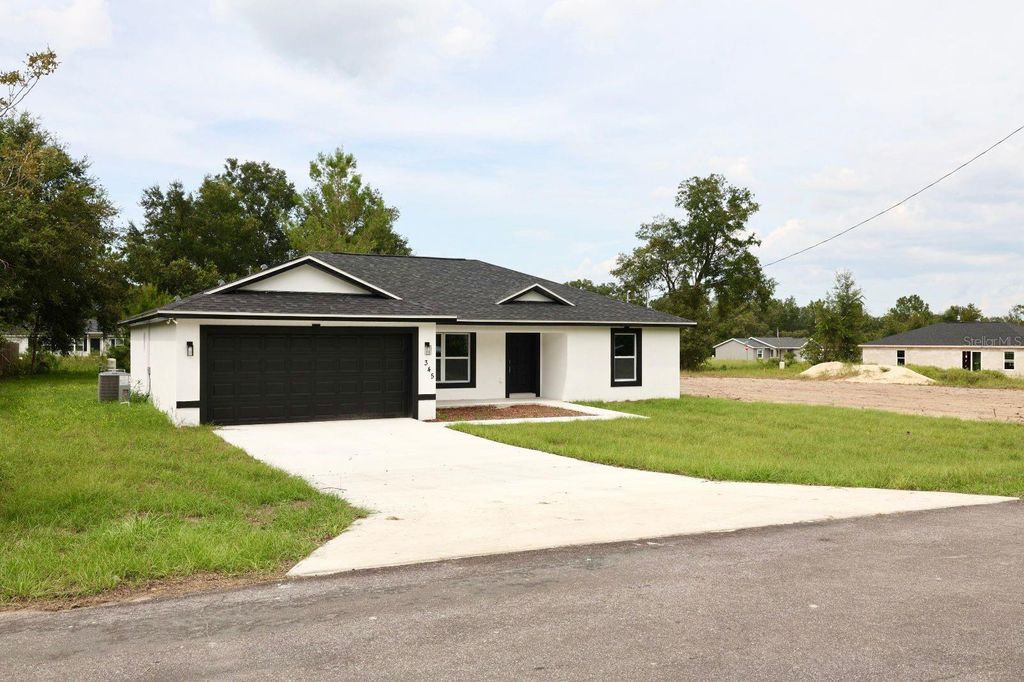 Photo of 345 Malauka Loop, Ocklawaha, FL 32179 (MLS # O6338775)