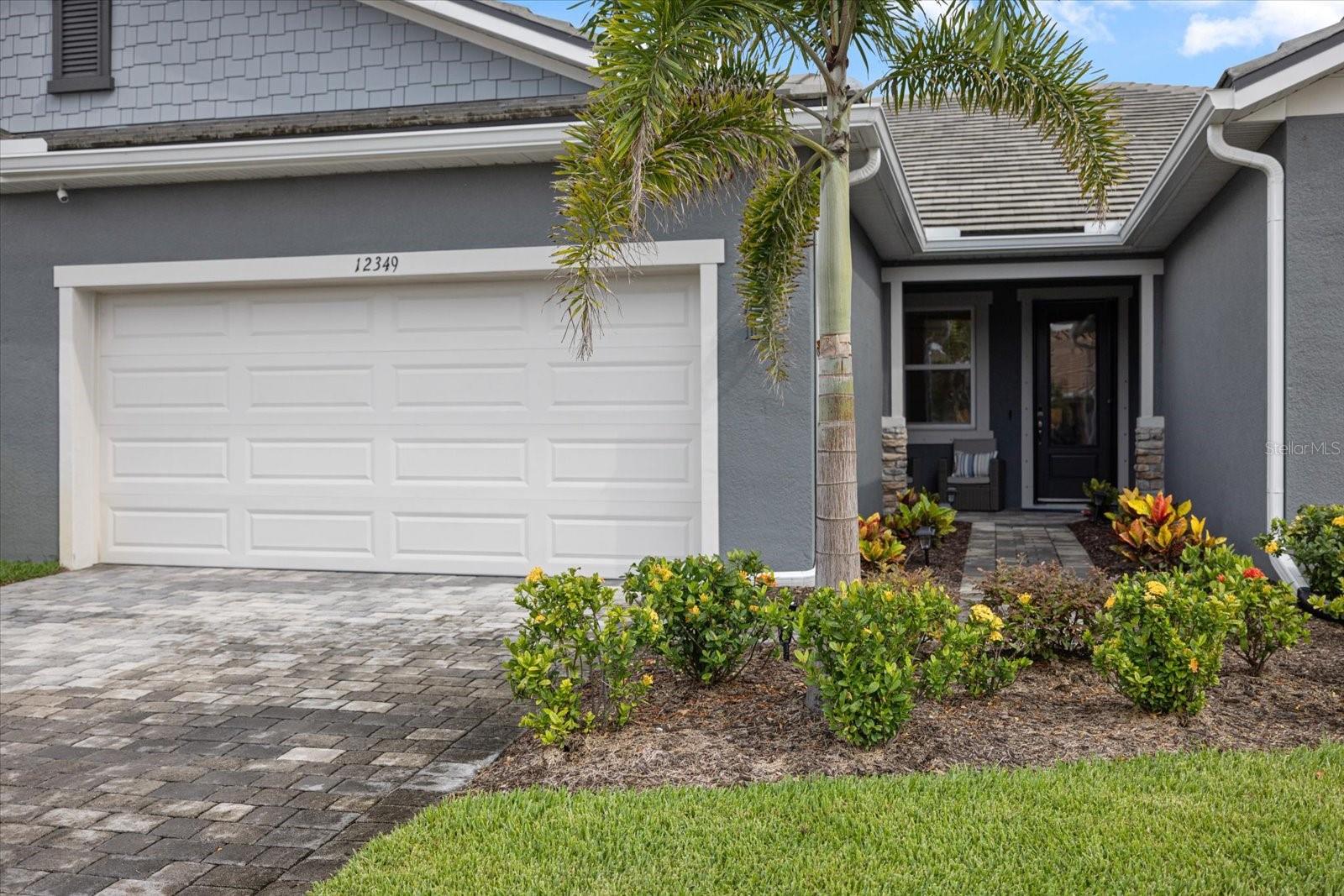 This stunning, move-in-ready villa in the sought-after community of Sunstone by Mattamy boasts over $53,000 IN THOUGHTFULLY SELECTED UPGRADES and a layout that blends luxury with low-maintenance ease. Step inside to find elegant tile flooring, crown molding throughout, and a sun-soaked great room with oversized sliding doors leading to your private enclosed lanai — perfect for morning coffee or evening wine. The open-concept kitchen is a chef’s dream, showcasing premium cabinetry with pull-outs, quartz countertops, upgraded stainless steel appliances, under-cabinet lighting, tile backsplash, and a walk-in pantry. Additional modern touches include a smart thermostat and whole-home security system, offering both comfort and peace of mind. The smart split-bedroom floor plan offers privacy and comfort. Your spacious primary suite is tucked away at the rear of the home, featuring a tray ceiling, spa-style bath with frameless walk-in shower and bench, dual quartz vanities, upgraded fixtures, and a generous walk-in closet. Two additional bedrooms are located up front, including one currently used as a home office. Each secondary bedroom offers ample closet space, ceiling fans, and enhanced LED lighting, all conveniently situated near the upgraded hall bath and laundry room with upper cabinets. Just a short stroll away, you’ll enjoy access to the brand-new amenity center — complete with a beach-entry pool, hot tub, pickleball courts, dog parks, event lawn, and indoor/outdoor gathering spaces. A full-time Lifestyle Director curates fun and engaging activities for residents year-round. Whether you're living here full-time or just part of the year, maintenance-free living makes it easy to simply lock up and go — no worries, no hassle. And with Downtown Wellen Park, CoolToday Park, Braves spring training, and the gulf beaches of Venice just minutes away, the best of Florida is always within reach. Call today for a complete list of upgrades and to schedule your private tour!