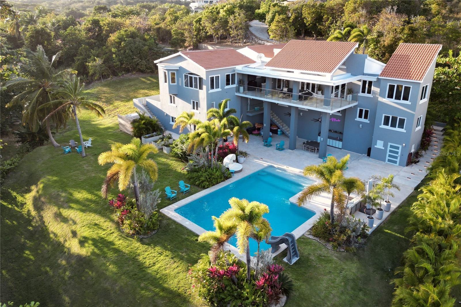 Looking for the ultimate luxury retreat? Look no further than this magnificent contemporary home located in the world-renowned Palmas del Mar resort in Humacao on the east coast of Puerto Rico.
This stunning 6,011 sqft home boasts 5 spacious bedrooms and 7 luxurious bathrooms, providing ample space for you and your guests to relax and unwind. The main living area features an additional 700 sqft covered deck with breathtaking ocean views, perfect for hosting gatherings and enjoying the stunning natural beauty that surrounds this gem.
Step outside and discover your own private resort-style pool (41’x27’) set on a beautifully landscaped 1,845 m2 parcel of flat, usable land. The outdoor living space includes a 2,500 sqft patio with wet bar, prewired and plumbed for a pool house, as well as a vegetable garden for all your culinary needs.
The property also features a 2-story guest apartment with a 2nd kitchen and separate entrance, providing a rentable income stream or extra space for guests.
But that's not all – just steps away from your front door, you'll find the secluded Shell Castle beach, where you can relax in peace and soak up the sun.
For added peace of mind, the property comes equipped with a new 30kw generator and transfer switch, as well as state-of-the-art security features including cameras, alarms, lighting control, landscape lighting, and irrigation.
Looking to expand your property even further? The adjoining lot (24) is also available for sale, providing an additional 1,181.24 m2 of space for whatever your heart desires, whether it's additional outdoor living space or your very own private tennis court. The lot is priced at $275,000, making it a steal for any savvy investor.
And best of all, this property is located within the world-renowned Palmas del Mar resort, which boasts a plethora of world-class amenities, including miles of coast, golf cart paths, two championship golf courses, tennis courts, pickleball courts, an equestrian center, beach club, a Pterocarpus forest, restaurants, shops, bank, churches, supermarket, professional services, and a private PK-12 college prep school. Imagine driving to school in a golf cart – it doesn't get any cooler than that!
Don't miss out on this once-in-a-lifetime opportunity to own your very own piece of paradise in the heart of Puerto Rico. Schedule a viewing today and start living the luxury lifestyle you've always dreamed of.
