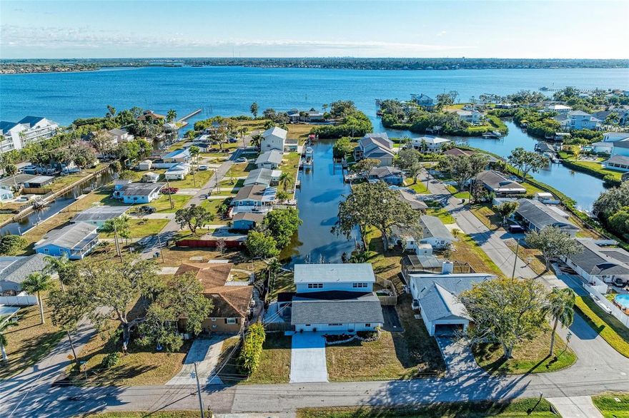 This home is a Boater’s Dream in Paradise! A rare riverfront, turnkey find on the North side of the Manatee River with an easy access to I-75 or 1-275 for your commute to Bradenton, Sarasota, Parrish, or St. Petersburg or to Anna Maria Island within 15 to 30 minutes by boat. Convenience abounds with excellent infrastructure close by.  This newly updated 3-bedroom, 3-bath waterfront home has a large canal, with a raised cement seawall, 10,000 lb. motorized boatlift AND dock. Just the push of a button and you are launched into the Manatee River. The home is situated at the end of the canal on a private closed outlet. Enjoy unobstructed water views and spectacular sunsets from nearly every room in the home. Inside or outside, the whole property is ideal for lazy afternoons of entertaining friends after a day on the water. 
The home offers two large primary bedroom suites (one on each floor), media room, several living areas, and a large, covered lanai. Don’t forget the third bedroom (on the first floor) with adjacent bathroom. The lower bedrooms have exterior entrance to the back yard. Large double pane windows (with custom sunscreens) add to the ambiance of Florida waterfront living and relaxation. The first floor has porcelain tile throughout and oak hardwood floors upstairs. The home is equipped with a two zone central air-conditioning system for efficiency. A separate laundry/pantry area is located off the designer kitchen which includes Kraftmade cabinetry with pullouts and granite countertops.  The right side of the home has a perfect area for boat or RV storage with a dedicated 30 amp hookup and sewer close by. NO DEED RESTRICTIONS, HOA or CDD fees. The house can be used as a VRBO/Airbnb and can be sold turnkey. THIS MOVE-IN ready home has UPGRAGES galore.