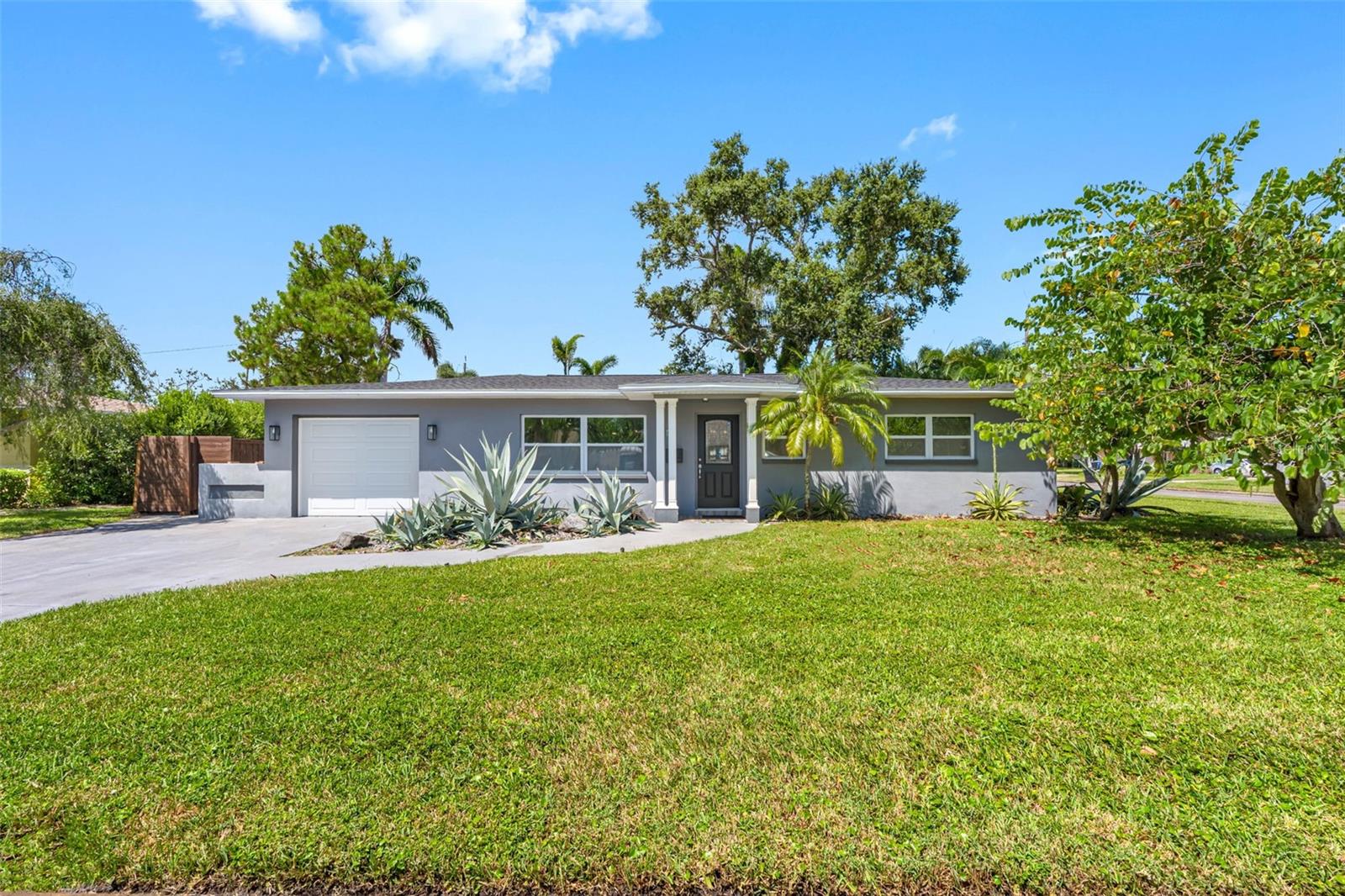 BRAND NEW ROOF! Welcome to Snell Isle living at its best. This contemporary, residence sits proudly on a sunny corner lot, a block-constructed home surrounded by million-dollar neighbors and just moments from vibrant downtown St. Petersburg. Museums, galleries, and fine dining are minutes away, while quick access to I-275 places Tampa International Airport and Clearwater within easy reach. Inside, a spacious open floor plan effortlessly connects everyday living with effortless entertaining. The beautifully updated kitchen features granite countertops, stainless steel appliances, a new dishwasher, a new hot water heater, while three fresh, bright bathrooms serve three generously sized bedrooms. A dedicated home office, play room, exercise gym or den provides the perfect spot for work, hobbies, or working out. Life here extends outdoors. Step into a manicured garden wrapped in green foliage, an inviting setting for morning coffee or evening gatherings. This yard is large enough for a pool! The property includes a one-car garage plus off-street parking for plenty more cars, a brand-new roof for peace of mind, and the ability to move the back fence 10 feet to create even more usable yard space. On weekends, stroll, bike, or jog along Coffee Pot Boulevard where Tampa Bay’s scenic views never disappoint. Come home to comfort, convenience, and the coveted Snell Isle lifestyle—your perfect place to call home.