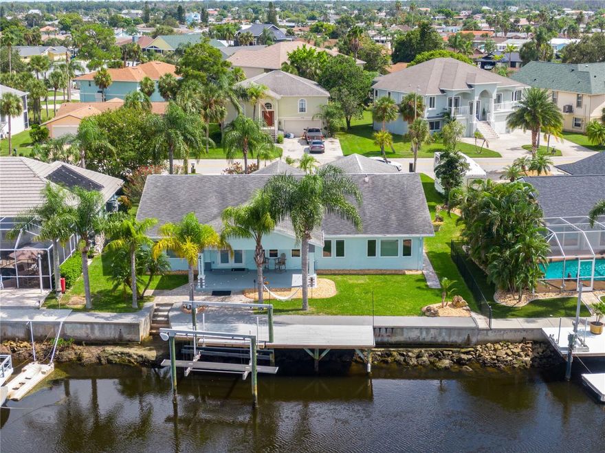 One or more photo(s) has been virtually staged. Completely renovated 3100+ sq ft waterfront ranch in Gulf Harbors Woodlands! This open concept home features a chef's kitchen w/ ice maker, double door refrigerator, soft close wood cabinetry, LED lighting and bonus flex room for office, nursery or gym. Canal-front w/10,000 lb boat lift+45x12 dock for easy Gulf access. Dual-zoned A/C and modern finishes throughout. Community offers pool, private boat ramp and optional Gulf Harbors Beach Club membership with private beach, volleyball, concerts and event rentals. Florida waterfront living at its best!