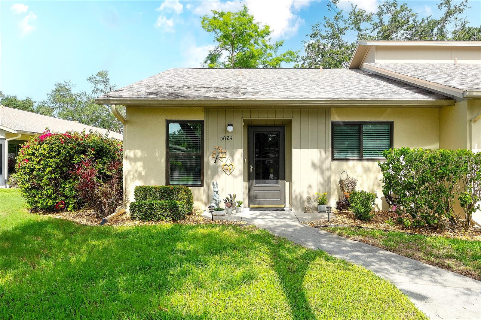 This beautifully updated, 2 bedroom/2 bath, garden style condominium home in the highly desirable, ALL SINGLE-STORY Huntington Woods community. The updates include HIGH IMPACT RESISTANT HURRICANE WINDOWS, remodeled kitchen with stainless steel appliances, convection oven, built-in microwave with drop-down air filtration, Cambria quartz countertops and room for an eat-in table. The kitchen looks out into the dining/great room area with luxury vinyl plank flooring, vaulted ceiling and bright dimmable LED light fixtures throughout. The fully updated and brightly lit bathrooms include Italian porcelain tile surrounds, Cambria quartz counters, built-in marble niches and marble trim, and Kohler sinks. The A/C system was replaced in 2021 and has a smart Wi-Fi thermostat (adjust it from anywhere). The laundry room has a new full-size washer and new dryer. The master bedroom has room for a King bed and features an ensuite bathroom and a new custom walk-in closet, with many more closets throughout the home. The forward-looking condo association has relatively low monthly condo fees thanks to fully funded reserves, and all updates have been completed: new roofs, repainting, and updates throughout the community. All buildings are SINGLE STORY (none of the issues with high-rise condos) with only four condos in each building, making for a quiet, relaxing community. This condo includes its own assigned covered parking space and ample open parking nearby. The monthly condo fee includes property management, grounds, pool, and building maintenance and insurance, Spectrum high-speed Wi-Fi and cable. Huntington Woods is ideally located between downtown Sarasota and downtown Bradenton. It is close to beaches, preserves and parks, world class restaurants, shopping, IMG Academy, golf, tennis, gyms, and healthcare.