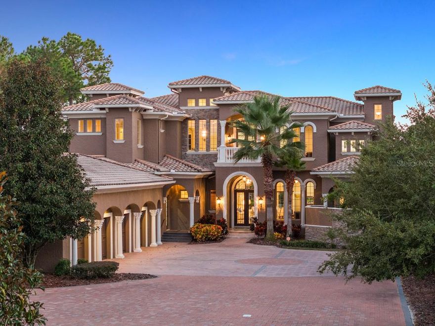 This ready to move-in estate home is rich in detail with plenty of natural sunshine with Southern exposure. From the second you enter you feel a sense of space with soaring 28 ft ceilings and oversized windows overlooking the rear pool and patio. Detailed workmanship is seen throughout with coffered ceilings, triple tray crown molding, custom trim, and elegant cabinetry. The master enclave features a large breakfast bar, separate his and her full bathrooms and 3 oversized closets. The lady’s closet with built in features measures 32 x 9! The master bath offers double vanities, free-standing step-up island tub and large walk-in shower with private bay window, separate toilet, and bidet. A large travertine fireplace in the formal living room complements the living room and bar area that leads into the kitchen. The kitchen’s custom solid wood cabinetry, center island with sink, Wolf and Sub Zero appliances are surrounded by plenty of granite countertop space overlooking the family room and large breakfast nook. Also located on the first floor is the formal dining area, theatre room, secondary guest suite with en suite bathroom and walk in closet, laundry, and wine room. The home is built with the capability of adding an elevator. A winding travertine staircase leads to the second floor overlooking the spacious first level. Three additional guest rooms with ensuite bathrooms and walk in closets are perfect for visiting guests and family gatherings. There is a tremendously large game room and bar area which extends to the large outdoor patio overlooking lake Apopka.  In addition, there is a front balcony and rear corner wrap around balcony with long range scenic lake views. The outdoor living space is perfect for entertaining and features a covered outdoor kitchen with fireplace, secondary covered fire pit/sitting area and an abundance of open poolside patio space. The heated salt water pool is large enough to swim laps or just relax in the spa. This home within the guard gated golf community of Bella Collina can only be appreciated in person. It is beautifully crafted and meticulously maintained. Enjoy the wide variety of amenities offered at the Club at Bella Collina including year-round social and culinary events, the Nick Faldo designed 18 hole golf course, Har-Tru tennis facility, pickleball courts, spa, fitness center with complimentary fitness classes and restaurants. Just minutes from Montverde Academy and downtown Winter Garden restaurants and shops. Call today to set your appt to preview this exclusive estate home- by appointment only.