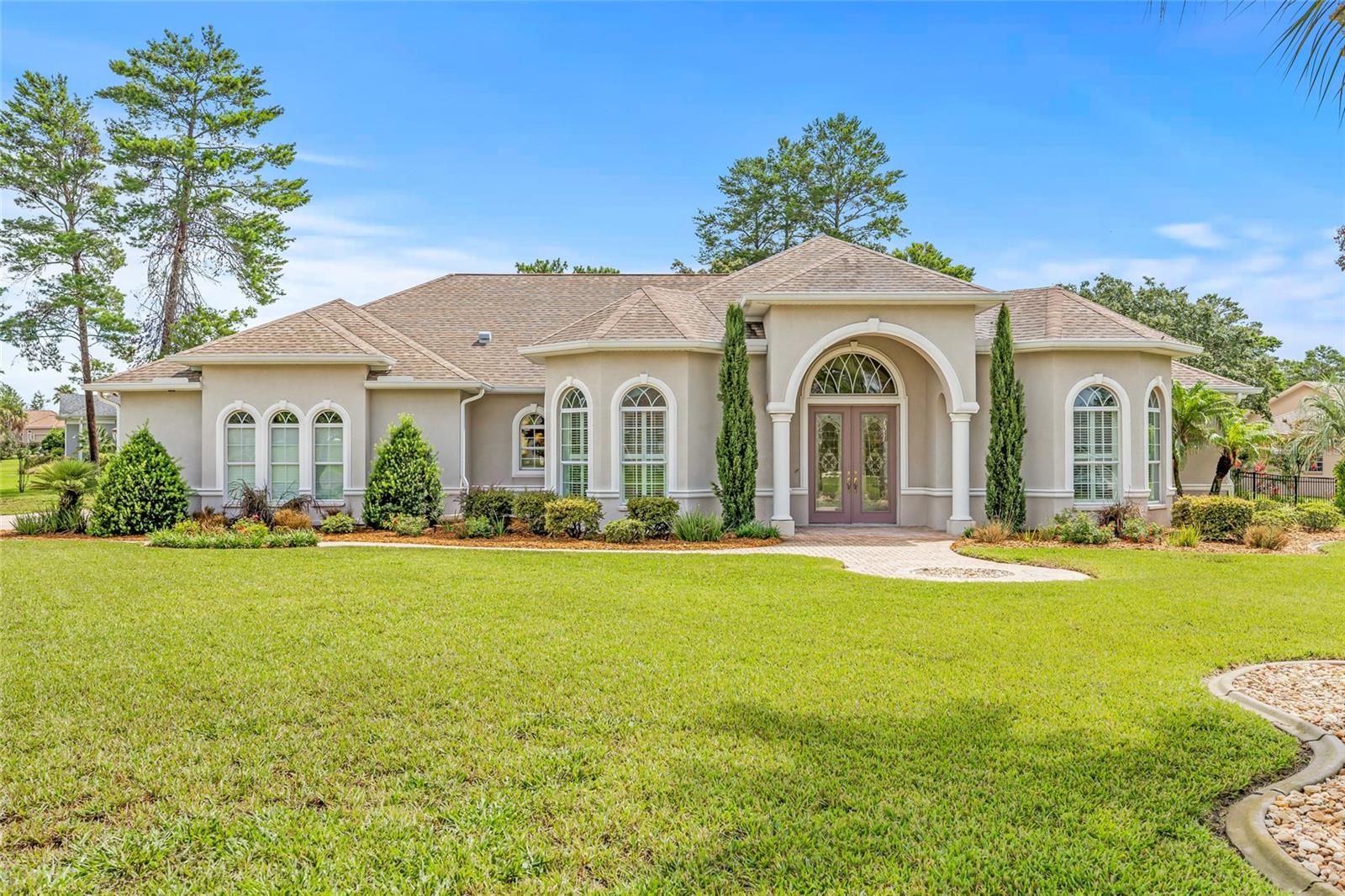 This is a one-of-a-kind custom home, built in 2010, sitting on a spacious 0.63-acre corner lot with incredible curb appeal and a long list of thoughtful upgrades inside and out. With a split floor plan, 3 bedrooms, an office, 2.5 bathrooms, and outdoor living space, this home is anything but typical as no detail was overlooked.
Inside, you’ll find travertine tile throughout and 10-foot ceilings in every room, with the formal living room standing out thanks to its 14-foot coffered ceiling, LED accent lighting, and crown molding. The separate office also features a coffered ceiing, built in cabinetry, and beautiful hand-carved glass doors—perfect for working from home in style.
The kitchen is both functional and inviting, with custom maple cabinets, pull-out drawers, granite countertops, a gas cooktop, newer stainless appliances, and even electrical outlets above the cabinets for accent lighting or holiday décor. Just off the kitchen, the dining room includes a built-in cabinet, crown molding, and a decorative ceiling medallion.
The primary bedroom has its own pool access, another coffered ceiling, dual walk-in closets with hidden storage, and a large en suite bath with a jetted tub, walk-around shower, and dual marble vanities. One of the guest bedrooms also opens to the pool, and the other includes an extra-large closet. A Jack & Jill bathroom connects the two with wood cabinetry, granite counters, dual sinks, and a tub/shower combo. There’s also a half bath conveniently located off the main living area with direct pool access.
Step outside to your own backyard retreat, complete with a saltwater, solar-heated pool and a gas fireplace under a fully re-screened cage (with Florida glass, done in 2024). There’s also a propane hookup for a grill, newer pool motor (2023), new salt cell and hosting unit (2024), and new outdoor fans and security lighting.
Additional highlights include: NO FLOODING or STORM DAMAGE from hurricanes. New landscaping with mulch and drip system, New Rainbird sprinkler timer (2025), New water softener, Central vacuum, Crown molding throughout, Gas tankless water heater and 125-gallon propane tank, Newer 4-ton HVAC system with regular maintenance, Newer rod iron fencing, Well for irrigation.
This home has a solid, custom feel throughout—nothing cookie-cutter here. If you're looking for a unique home with space, quality finishes, and a true indoor-outdoor Florida lifestyle, this one is definitely worth a look.
Woodland Waters offers access to Tooke Lake with a private boat ramp, plus tennis and pickleball courts, and a community park. Daily conveniences like Publix and other shopping are just outside the neighborhood. You're only 15 minutes from Pine Island Beach for sunset views, kayaking, boating, fishing, and even swimming with manatees on the river—or spending the day at Buccaneer Bay Water Park. And with the Suncoast Parkway just 15 minutes away, getting to Tampa International Airport is quick and easy.