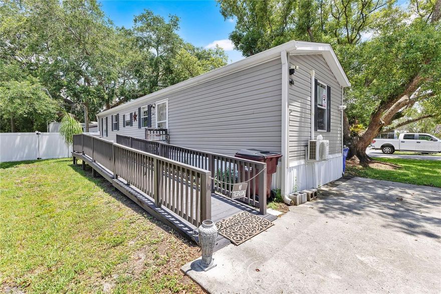 Positioned on a corner lot in the heart of Saint Cloud, this well-maintained manufactured home offers convenience, accessibility, and a central location just minutes from shopping, dining, major roadways, and the lakefront. Mature trees provide shade and character to the property, while the extended driveway offers ample parking space for multiple vehicles.

The home features a covered front entry with an accessibility ramp leading to the main entrance for added ease and functionality. Inside, the layout offers comfortable everyday living with natural light throughout. The spacious kitchen includes all appliances along with ample cabinet and counter space for daily living and meal preparation. Both bedrooms are similar in size and layout, while the two full bathrooms provide added functionality and convenience. The fenced portion of the yard provides privacy and space for pets, outdoor activities, or entertaining.

Adding even more versatility to the property, there is a 2014 camper located in the backyard that may provide potential extra income opportunities for an investor or additional space for extended family members.

Located just minutes from Downtown St. Cloud, East Lake Tohopekaliga, parks, restaurants, and local conveniences, this property presents a great opportunity for homeowners, seasonal residents, or investors looking for a centrally located property with no HOA.