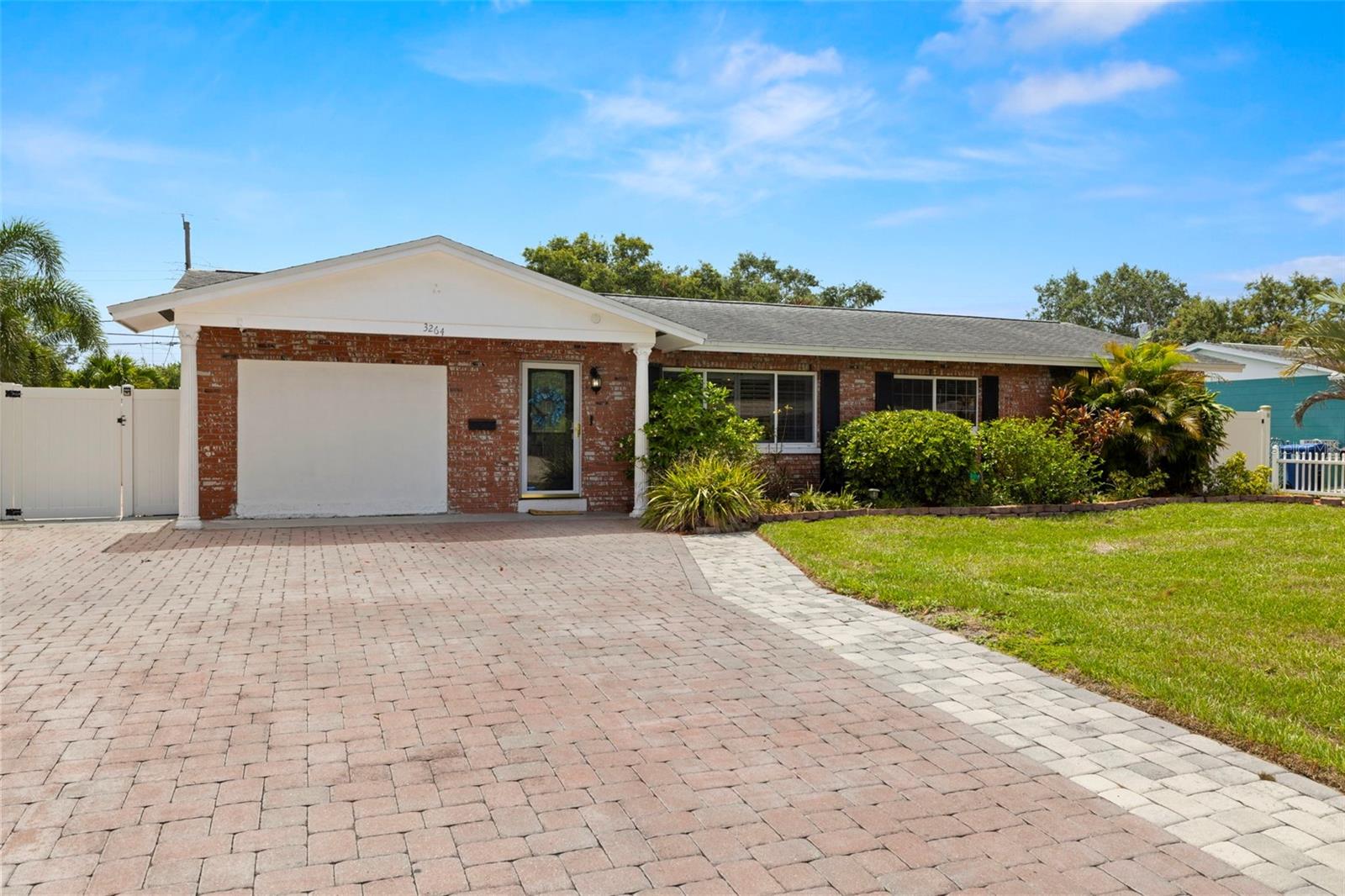 Welcome home to this completely remodeled pool home in the heart of Westgate Manor! Situated high and dry in Flood Zone X and Evacuation Zone E, this home offers peace of mind during storm season and checks every box for comfort, function, and style. Thoughtfully redesigned and fully permitted in 2023, the remodel includes the addition of a second primary suite, creating a spacious 4-bedroom, 3-full bathroom split layout perfect for multi-generational living, guests, or work-from-home flexibility. Step inside to discover luxury vinyl plank flooring throughout, a modern open-concept floor plan, and a gorgeous chef’s kitchen with custom soft-close cabinetry, granite countertops, a large central island, and stainless steel appliances. The two living spaces offer room to relax and entertain, with seamless flow out to the screened lanai and pool area. The pool/spa combo is the showstopper — complete with a new motor, water heater, and wireless smart controls for easy enjoyment. Surrounded by upgraded paver walkways, you’ll find two versatile storage sheds, mature tropical landscaping, and space to garden, play, or unwind by a firepit. Inside, both primary suites offer privacy and modern updates, with the north wing suite featuring French doors with direct pool access. The largest of the two primary suites is beyond spacious, offering a true retreat with French doors that lead directly outside, a walk-in closet, and a spa-like en-suite bathroom. Unwind in the double-head walk-in shower, soak in the freestanding tub, and enjoy the functionality and style of a large double vanity topped with an LED mirror. The guest bathroom boasts a tub/shower combo, glass door, and a Bluetooth speaker/light — the perfect mix of form and function. The oversized paver driveway offers parking for up to six vehicles, making it ideal for gatherings or multi-car households. The gentle slope adds character and curb appeal, while the spacious front lawn provides a welcoming first impression and room for landscaping, play, or simply soaking up the Florida sunshine. Located just minutes from the shops and dining along Tyrone Blvd, the Northwest Rec Center, I-275, downtown St. Pete, and our world-famous beaches — this one has it all. This is the move-in ready, fully updated pool home you’ve been waiting for! Come see it today and fall in love with everything it has to offer. Bonus: If you love the vibe and want to skip the hassle of furnishing a new place, the home can be negotiated fully furnished — just bring your suitcase and start enjoying the Florida lifestyle from day one.