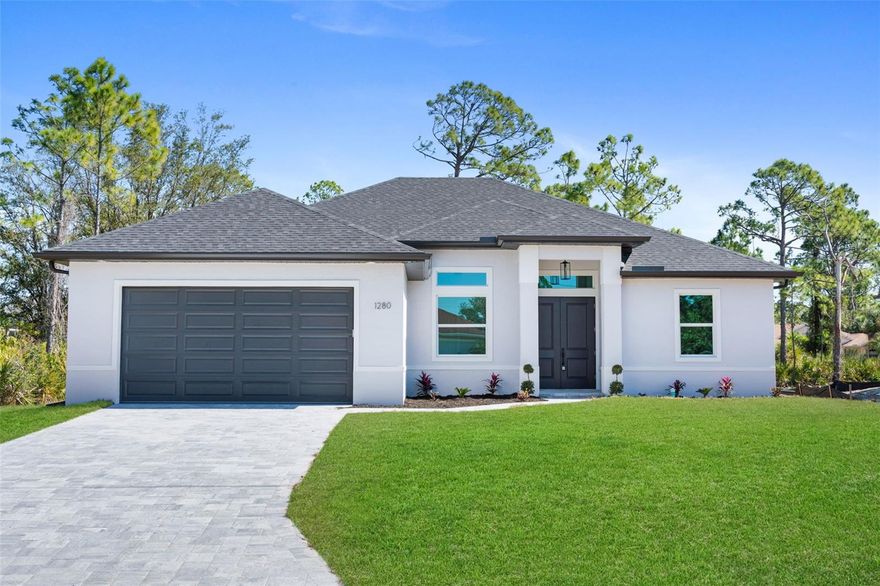 MOVE-IN READY NEW CONSTRUCTION with full hurricane IMPACT windows and doors, an oversized garage, and a spacious covered lanai pre-plumbed for your future outdoor kitchen. This beautifully designed home offers 3 bedrooms, 2 bathrooms, plus a versatile den that can easily serve as a 4th bedroom, office, or flex space. From the moment you enter, you’ll be impressed by the soaring tray ceilings, and expansive triple impact sliding doors that open to the oversized lanai and private backyard, creating the perfect indoor-outdoor living experience. The heart of the home is the stunning chef’s kitchen, featuring an 8 foot quartz island, upgraded high-end LG stainless steel appliances, abundant cabinetry, and a spacious breakfast nook, ideal for entertaining or everyday living. The luxurious primary suite offers tray ceilings, a large walk-in closet, and a spa-inspired bathroom complete with dual vanity, walk-in showers with glass enclosures, and an expanded layout designed for comfort and convenience. Additional premium upgrades include: Full hurricane impact windows and doors Underground utilities for improved reliability Paver driveway and upgraded landscaping package Large covered lanai with plumbing for outdoor kitchen Extended oversized garage designed to accommodate larger vehicles or trucks Recessed A/C system in garage for optimized storage and climate control Luxury LVP flooring throughout Glass French door in den Laundry room with built-in cabinetry Upgraded, elongated toilets and upgraded Moen Genta Facettes Nest WiFi smart thermostat for remote climate control Flood Zone X location for added peace of mind Every detail of this home was carefully selected with quality, durability, and luxury in mind. This property offers the perfect combination of modern design, functional layout, and premium upgrades—ready for you to move in and enjoy.