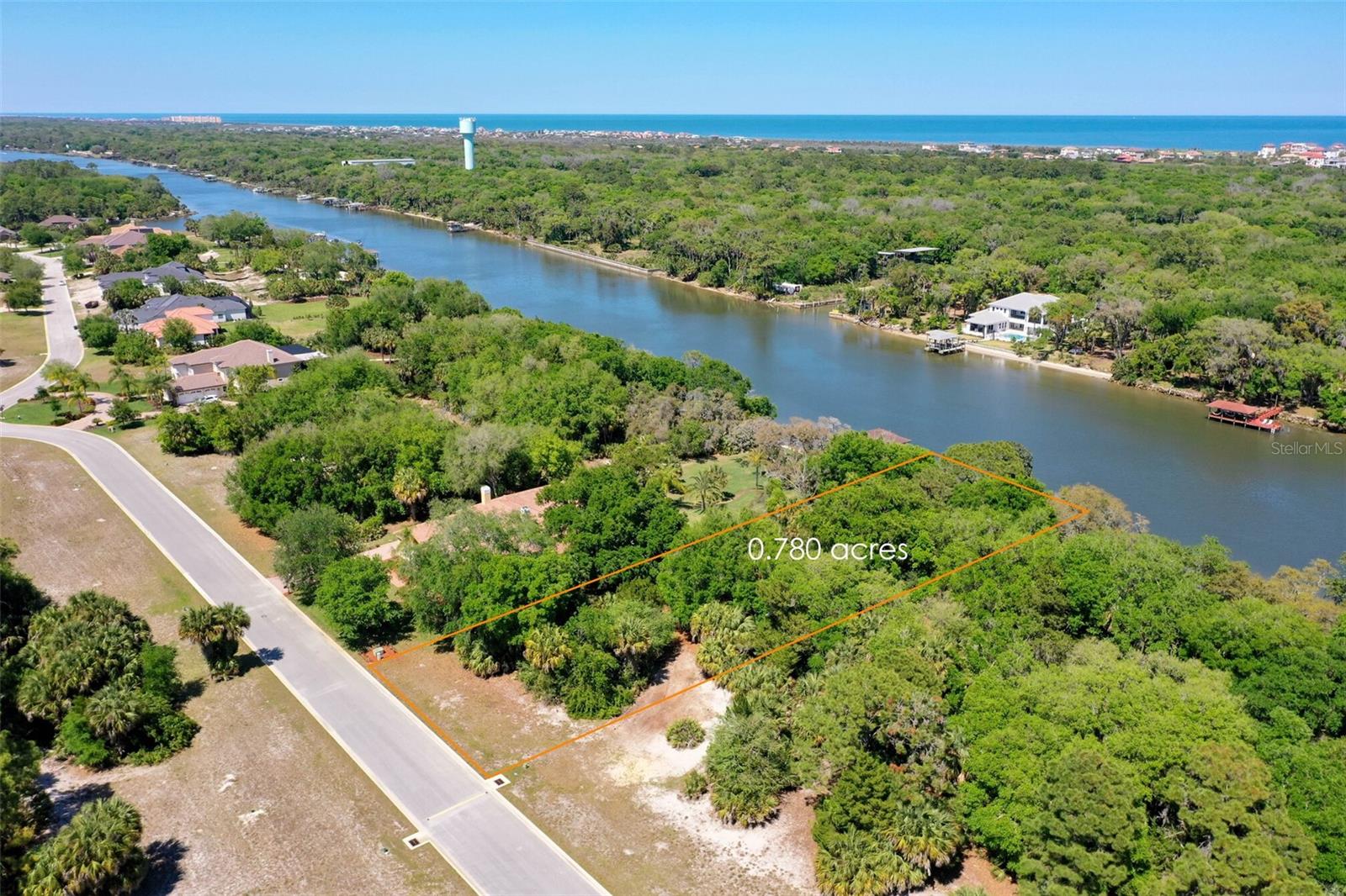 Here is your opportunity to own this pristine 100 feet wide of direct intracoastal waterway lot located in a private gated island community of amazing Estate size homes and homesites of the Sanctuary. The moment you cross it's private bridge and pass the imposing gate/guard house you will understand why this place is called the Sanctuary. It's serene setting of lovely ponds, mature oak trees, fountains, sidewalks... all abundant of waterflow and wildlife sightings. There are paved and manicured walkways, biking and jogging trails. Watch all the activity on the intracoastal, from the dolphins to the manatees, fish, birds, to the sail boats cruising by and enjoy boating and fishing from your own backyard. This community features underground utilities, including piped propane gas. Low HOA fee of $165.00 monthly. No build out time and you can choose your own builder. Enjoy the Florida lifestyle that your are seeking and make this site your own SANCTUARY!!!