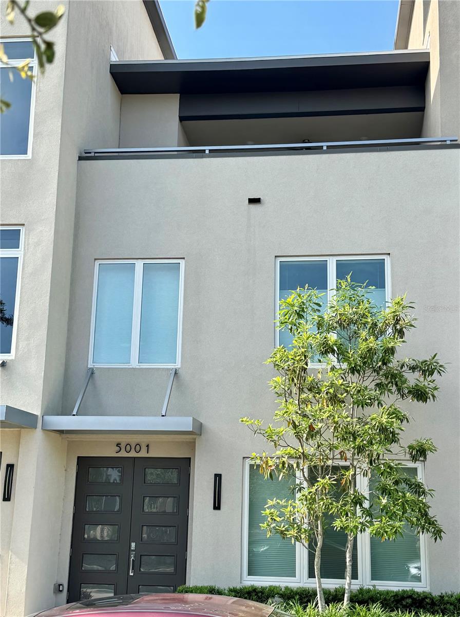 One-of-a-kind Luxury townhome in Celebration Pointe. This spacious 2000+ square foot home provides a shaded north-facing rooftop terrace off the third floor Primary Bedroom Suite. After you enter the town home from the private 2-car garage, you can pass by the laundry room and guest suite to take the stairs, or just hop on your elevator! The main living area is on the second floor, offering plenty of natural light, solid-wood sleek cabinets, and guest bathroom. The VUE at Celebration Pointe is proximate to dining, entertainment, transportation, and has a beautiful VUE pool, spa, and cabana. In addition, The relatively low HOA fee covers 24-hour security patrol, exterior maintenance & insurance, interior pest control, and will have entry and exit gates. Experience some nature with your urban-living: the entire west side of The VUE at Celebration Pointe abuts the 700-acre Kanapaha Nature Preserve, so you are likely to see Sandhill Cranes and deer off of the pool deck. Schedule a showing to see this remarkable low-maintenance lifestyle home.
