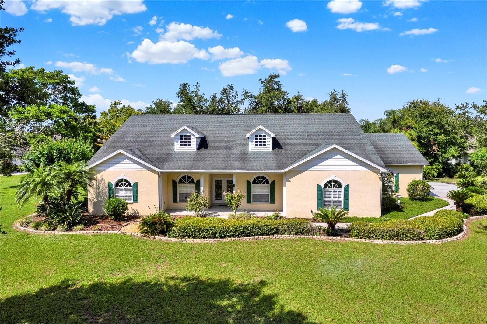 What a fantastic opportunity to own a great large home in a highly desirable community. Great blank canvas to create your masterpiece home. This dream home sits on a pristine 1+ acre corner lot, with mature well manicured landscaping, large shade trees and plenty of room for a pool if you wish. The long drive-way leads to this 4 bed 3 bath 3 car garage stunner. Beautiful wood floors are the canvas for your design choices. The kitchen has been recently updated with gorgeous wood cabinets and granite counters. Custom plantation shutters throughout. All three baths also include granite vanities, the primary boasts dual sinks, garden tub with separate large shower, private toilet closet and two large walk-in closets. The large primary bedroom is wide open with one of the three sets of French doors to access the oversized screened in back patio. Formal dining and an eat-in kitchen nook area. The three other bedrooms are positioned to host large families or guests. The patio stretching across entire back of home lets you enjoy the many birds and butterflies that visit the beautiful yard. Possibility is only limited to your imagination. The property is near I-4 and other major highways to access Tampa and Lakeland and Orlando, within 20 minutes and beaches in 30 minutes.