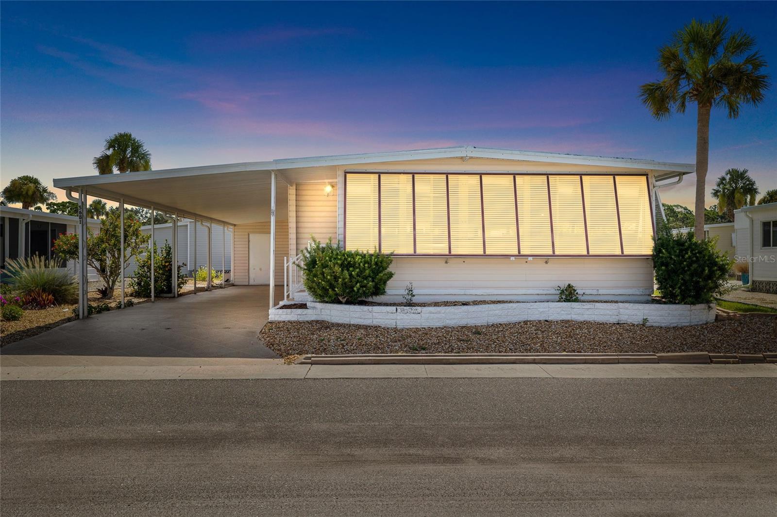 Motivated seller! Less than 2 miles from the beach! This well-maintained 2BR/2BA doublewide sits on an oversized lot in the popular 55+ resident-owned community of Japanese Gardens. Enjoy nearly 200 extra sq. ft. of air-conditioned space in the expanded Florida room with a dedicated A/C unit. Highlights include an updated kitchen with Corian counters, newer appliances, in-home laundry, and a spacious primary suite with double vanity, walk-in shower, and large walk-in closet. Bonus features: vinyl siding, Bahama shutters, updated windows, and a large storage shed—perfect for your beach gear. Minutes to the Gulf and move-in ready!