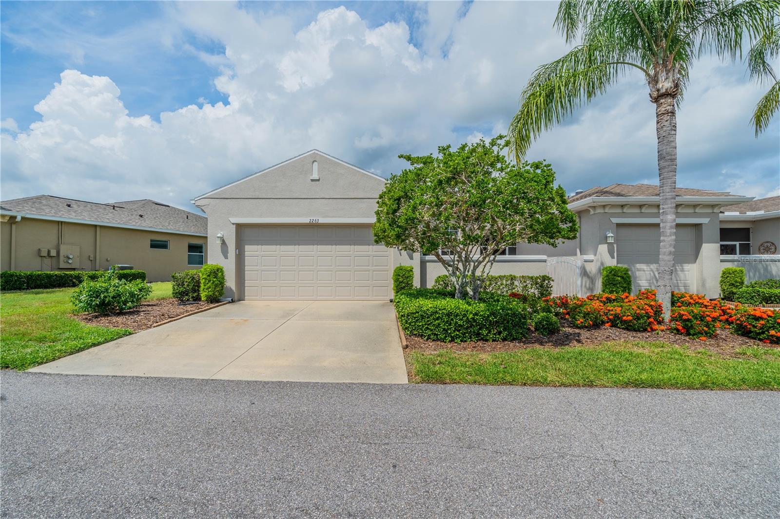 Welcome to your new home in sunny Florida! This Baybrooke model is located in the much sought after Maplewood Association of Kings Point. The house features an entry with a large (19'X16') semi-private paver courtyard for outdoor relaxation or dining, which leads to a covered and screened entry foyer. It offers a beautiful living area with living room, dining room, and kitchen all in an open floorplan. This living area with recessed lighting opens to an extended enclosed Florida room with AC. The Florida Room offers terrific pond views and is a great place for morning coffee or evening cocktails while you watch wildlife go by. There are quadruple sliders going to the Florida Room which gives a very open, airy view. The home has plantation shutters throughout. The kitchen is a dream as it has a breakfast counter with room for bar stools and features beautiful appliances including a gas stove. There is also a solar tube in the kitchen. The uniform kitchen cabinets have crown molding, sliding shelves and the kitchen includes a large walk-in pantry that is fully shelved. The room off the kitchen is great for dinette set or to use as an office/study area. The bedrooms are separate and give privacy to family and friends who may visit. The primary bedroom is spacious with an ensuite bathroom which has a large shower and dual sinks. The primary bedroom also has two walk-in closets. The second bedroom has a built-in wall safe in the closet. The cabinetry is the same throughout the home. Connecting the garage to the kitchen is a walk-through laundry room with a nearly new washer and dryer plus overhead storage cabinets. The two-car garage has a water softener, lots of shelving, and an extra refrigerator. The almost new garage door is extremely quiet! The furniture comes with the home but can be removed by seller if buyer doesn't want it. The home has KPW platinum plan in effect. This home has been very well maintained. It is close to the South Clubhouse, pools, and restaurant, and also near the back gate. Kings Point, between Sarasota and Tampa, is an ideal location. The 55+ gated community has terrific facilities, including five pools, two fitness centers, and over 200 clubs for your enjoyment. It is convenient to shopping, world class museums, Busch Gardens, Orlando, sports, and entertainment with wonderful beaches nearby. Come enjoy the Florida lifestyle! Schedule your viewing today