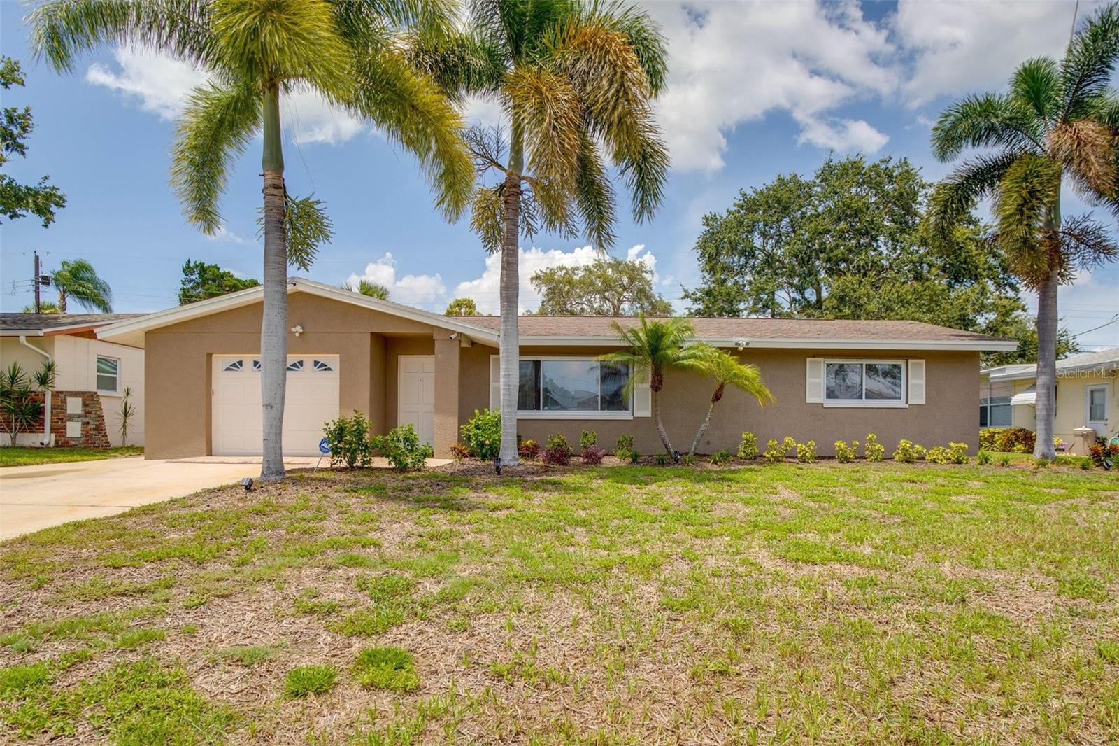 Imagine stepping into your own sun-drenched oasis just **2 miles** from the powdery white sand of Madeira Beach, where the gentle Gulf breezes carry the promise of endless sunsets and seaside adventures. This beautifully renovated 2-bedroom, 2-bath home has been lovingly updated from top to bottom—boasting a brand-new 7,500 dollar central A/C system, 7,500 of underground plumbing replaced all the way to the street, and 3,000 of lush, easy to maintain landscaping—and is offered fully furnished!