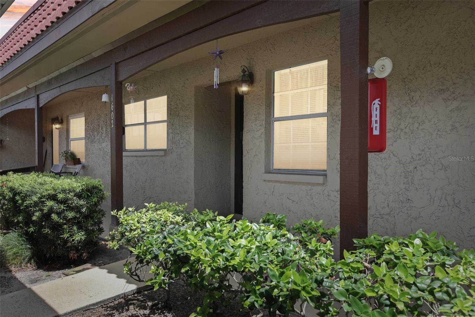One or more photo(s) has been virtually staged. Welcome to Pinewood Village, where your perfect retirement lifestyle awaits. This exceptional 55+ community is designed for comfort, convenience, and peace of mind. A Safe and Stylish Retreat - Live with confidence knowing that Pinewood Village is high and dry, providing a secure haven during hurricane season. This isn't just a place to live; it's a place to thrive. Step inside this move-in-ready, first-floor condo, designed for easy access and elegant living. The open layout creates a spacious, inviting atmosphere, while the updated kitchen with its modern finishes offers both style and function. Enjoy Your Days, Your Way. Whether you're starting your day with a quiet cup of coffee or winding down in the evening, the spacious, screened-in back patio is your private oasis. This serene space also includes a convenient in-unit laundry area. Beyond your front door, you'll discover a community brimming with amenities and activities. Stay active with the heated pool and shuffleboard courts, or socialize at the clubhouse. With a full calendar of events, there's always something to do and someone to meet. The Best of Both Worlds - Pinewood Village offers the perfect blend of peaceful, low-maintenance living and easy access to everything you love. You'll have a covered parking spot waiting for you, and a prime location puts you just minutes from stunning beaches, championship golf courses, fantastic shopping, and major airports. This isn't just a home—it's your new beginning.