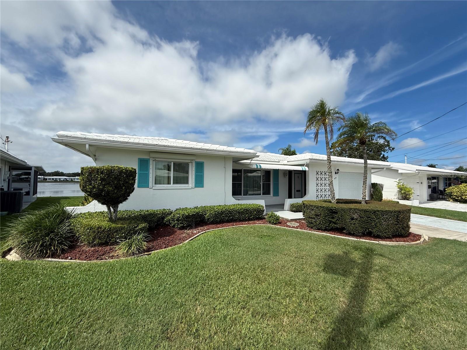 Lakefront Living in The Mainlands 55+ Community
Discover this beautifully maintained 2-bedroom, 2-bath lakefront home offering nearly 1,700 sq. ft. of living space plus an oversized 1-car garage. Move-in ready, the inviting floor plan with beautiful water views.
The central kitchen features wood cabinets, deep pull-out drawers, granite countertop, and newer appliances. Both bathrooms are stylishly updated, and the home includes impact windows, storm shutters, and newer garage doors for peace of mind.
This home comes fully furnished, including a high-quality bedroom set with the sleep number bed and an electric fireplace in the Florida room. Bedrooms are generously sized with ample closet space, and importantly—this property did not flood in recent storms.
Living in The Mainlands of Tamarac by the Gulf means enjoying a vibrant 55+ lifestyle. Built around an 18-hole public golf course, the community offers 7 clubhouses, heated pools, shuffleboard, and endless activities. The HOA takes care of it all—roof repair/replacement, cable, internet, water, sewer, trash, irrigation, lawn care, and exterior paint—ensuring truly worry-free living.
Perfectly located in Pinellas Park, you’ll be close to shopping, dining, both Tampa and St. Pete airports, and just 10–12 miles from the Gulf beaches. Schedule your showing today and experience the best of lakefront Florida living! BEST PRICED waterfront home in the community!