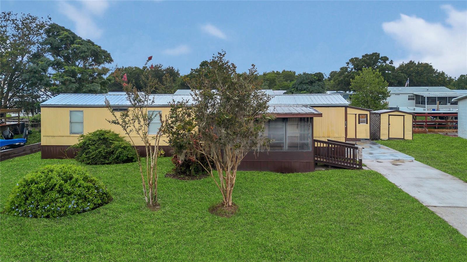 Welcome to this impeccably maintained 2-bedroom, 2-bathroom home offering comfort, style, and serene views in every direction. This home is perfect as a primary residence, vacation getaway, or investment property. Step inside to discover an open-concept floor plan featuring a light-filled family room that flows seamlessly into the dining area and kitchen. The kitchen is well-equipped with generous cabinetry, functional counter space, and all the essential appliances—ready for daily meals or weekend entertaining. What truly sets this home apart is the screened-in back porch, where you can unwind with your morning coffee or take in breathtaking sunsets overlooking peaceful conservation land and a tranquil water view. It’s the perfect spot to relax, reflect, and enjoy Florida living at its best. Located just minutes from Central Florida’s world-famous theme parks, beautiful beaches, and a wide variety of shopping, dining, and everyday conveniences, this home offers the best of both comfort and convenience. Don’t miss your opportunity to make this peaceful retreat your own!