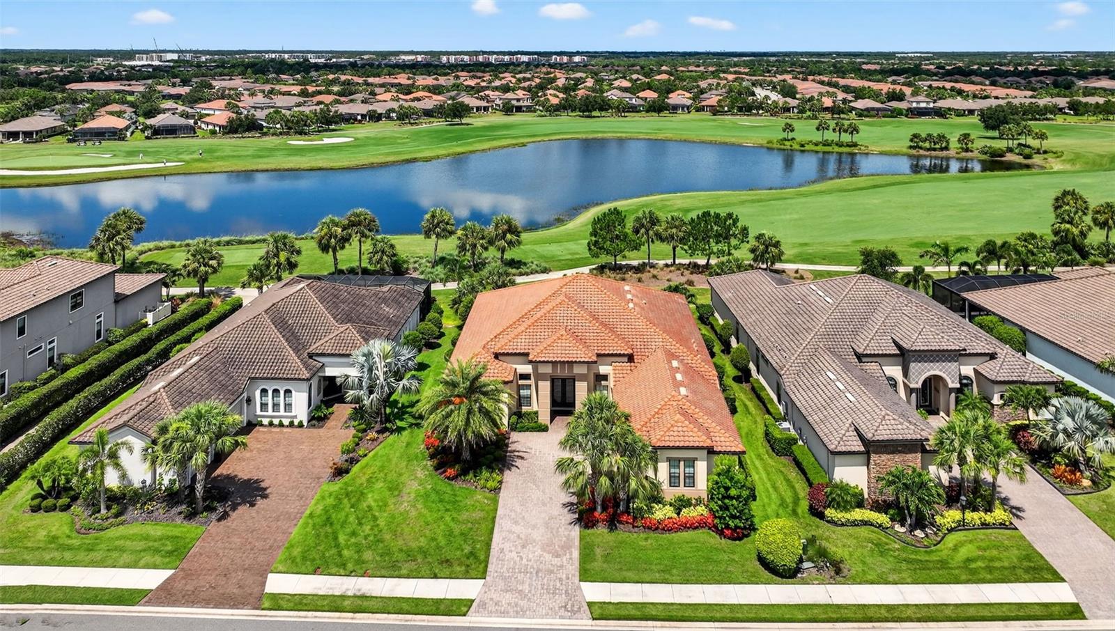 One or more photo(s) has been virtually staged. Elegant and Expansive Mercede Model with Golf & Water Views in Esplanade Golf & Country Club! Welcome to this stunning open Floor Plan, offering 3,276 sq. ft. of luxurious living space under air, featuring 3 bedrooms, 3.5 bathrooms, a private den, and a 3-car garage. Perfectly positioned on a premium homesite with breathtaking views of the 17th fairway and tranquil pond, this home blends timeless elegance with modern upgrades. Step inside through a double-wide front door and experience refined finishes such as double crown moldings in the great room, hardwood floors in the bedrooms, and tile flooring throughout the main living areas and bathrooms. Plantation shutters offer a custom touch, while the gas fireplace with built-in cabinetry and display shelves, surround sound system, and brass floor receptacles add both charm and functionality. The gourmet kitchen is a chef’s dream, complete with upgraded granite countertops, top of the line GE Monogram double ovens, gas cooktop with range hood, Viking refrigerator, Timberlake 42" cabinetry with crown molding, pull-out cabinet drawers, recessed LED lighting, an expansive island with extra storage, and a spacious walk-in pantry. Enjoy seamless indoor-outdoor living through 16-foot pocket sliders leading to a screened lanai featuring a summer kitchen with grill, sink and built-in refrigerator—all overlooking peaceful golf and tranquil water views. Additional highlights include a newer front-loading washer and dryer, hurricane impact windows on the front of the home, an irrigation system using reclaimed water, full home gutters, garage shelves, pull-down attic stairs, a whole-house chlorine filtration system serviced by Badger Bob’s, a Sentricon termite protection system, this exceptional residence is offered by the original owners and has been meticulously maintained in a pet-free and smoke-free environment. GOLF IS INCLUDED FOR TWO HOUSEHOLD MEMBERS. The community is built around healthy living and living well with unlimited exercise and social options. Esplanade offers a wide array of amenities and activities such as an 18-hole championship golf course, two resort pools, hot tubs, resistance pool, pickleball, tennis, bocce ball, two fitness centers, exercise classes, two dog parks, playground, firepit, spa/salon, an on-site lifestyle director, social events, and various clubs plus a Tiki bar. The state-of-the-art Culinary Center offers residents several dining options such as the Barrel House as well as catering services, wine tastings, and special events. Esplanade is located in the heart of Lakewood Ranch, close to I-75, Lakewood Ranch Main St., University Town Center, Sarasota Polo Club, shopping, dining, entertainment, hospitals, cultural attractions, boating, parks and Florida's famous sandy beaches. One or more photos has been virtually staged.