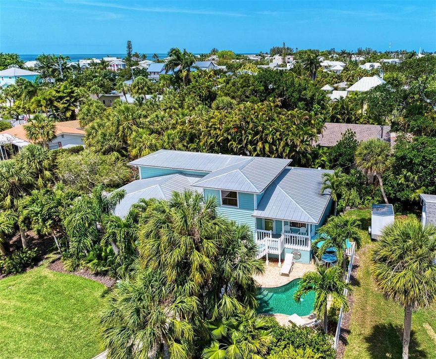 ONE OF A KIND - ELEVATED with a PRIVATE POOL & your own garage, this is like single family home living - for under $1m on Anna Maria Island!  This 2 bed/2 bath picture perfect, island dream is ideally situated on a quiet corner, just two short blocks from the Gulf Beaches!  This UPDATED island sanctuary surrounds you in coastal charm.  The luxury vinyl large plank flooring throughout is ideal for beach living, and ties the open living and dining room together.  The fully renovated kitchen with quartz counters, is equipped with stainless steel appliances and ample shaker style white cabinetry.  Your guests will enjoy their private accommodations just next to their updated full bath with white subway tile surround and new vanity with Moen faucet.  Upstairs you will relish the privacy of your primary retreat.  The sunlight brightens your spacious room that includes a large walk in closet.  Your en suite bath has a glass enclosed shower, with tile bench and pebble stone shower flooring.  And outdoors, you can relax on your front porch, or cool off in YOUR VERY OWN pool!  Embrace the island life in this lovely land condo, and use it as a short term rental when you are away. THERE IS NOTHING LIKE IT at this price - come make it your own today!