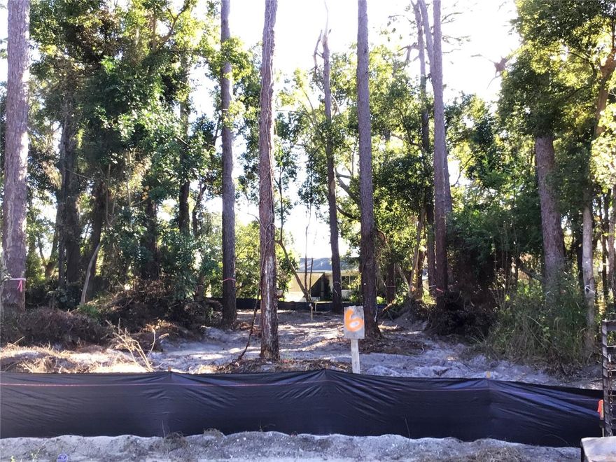 Site development is scheduled for completion in March 2026. The Estates at Eniswood is a small, private community featuring just seven residential lots, ideally situated and surrounded by the established Eniswood and Autumn Woods neighborhoods. Lot 6 is an interior lot on the cul-de-sac with mature trees offering added privacy. This is a Design & Build community, allowing buyers to bring their own home plan, design a custom home, or choose from existing plans offered by the builder. The minimum required living area is 2,000 square feet. All home elevations and site layouts are subject to developer approval to ensure architectural consistency throughout the community. All public utilities are underground, including water, sewer, electric, and natural gas. Property is located in Flood Zone X (X500) — no flood insurance required. Buyers must use the developer’s designated builder, Somerfield Construction. The Estates at Eniswood is located within the highly rated Palm Harbor school zone and is just minutes from downtown Palm Harbor, dining, shopping, local parks, Gulf beaches, the Tarpon Springs Sponge Docks, the Pinellas Trail, and more. Seller holds an active Florida Real Estate Broker License.