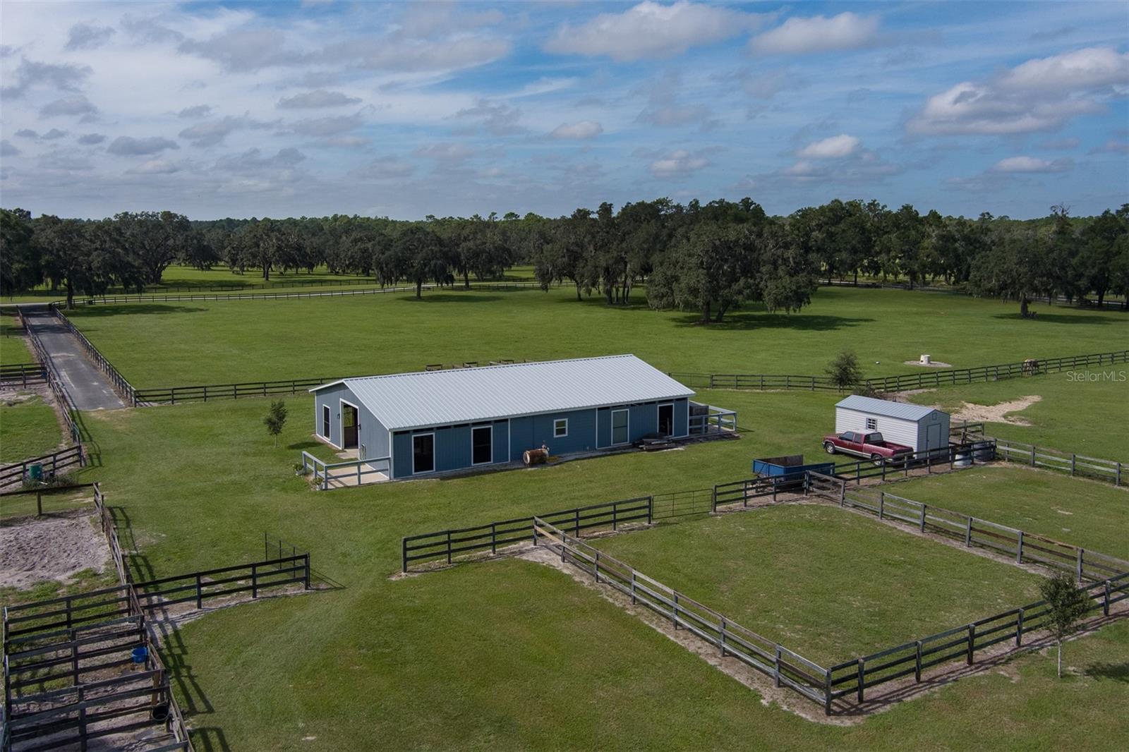 Located in the peaceful countryside of Ocala, this 20.09-acre fully fenced property offers the perfect balance of tranquility and proximity to world-class equestrian venues. Just 10 minutes from both the World Equestrian Center and HITS, this farm provides easy access to top-tier competitions while maintaining a serene, quiet setting for you and your horses. The property features a well-maintained 8-stall center-aisle barn with a sturdy wood frame construction. Designed with practicality in mind, the barn includes a barn office, bathroom, tack room, wash rack, and feeding stations, ensuring a smooth daily operation for your equine care. Additionally, a separate storage shed provides extra space for equipment, hay, or other supplies. With six established paddocks and two turnout pens, there’s ample space for turnout, training, and grazing, all surrounded by mature oak trees that offer natural shade and add to the picturesque beauty of the land. Plus, there is plenty of room for constructing an arena to further enhance the property's equestrian potential. This property offers a combination of location, quiet surroundings, and exceptional equestrian amenities!