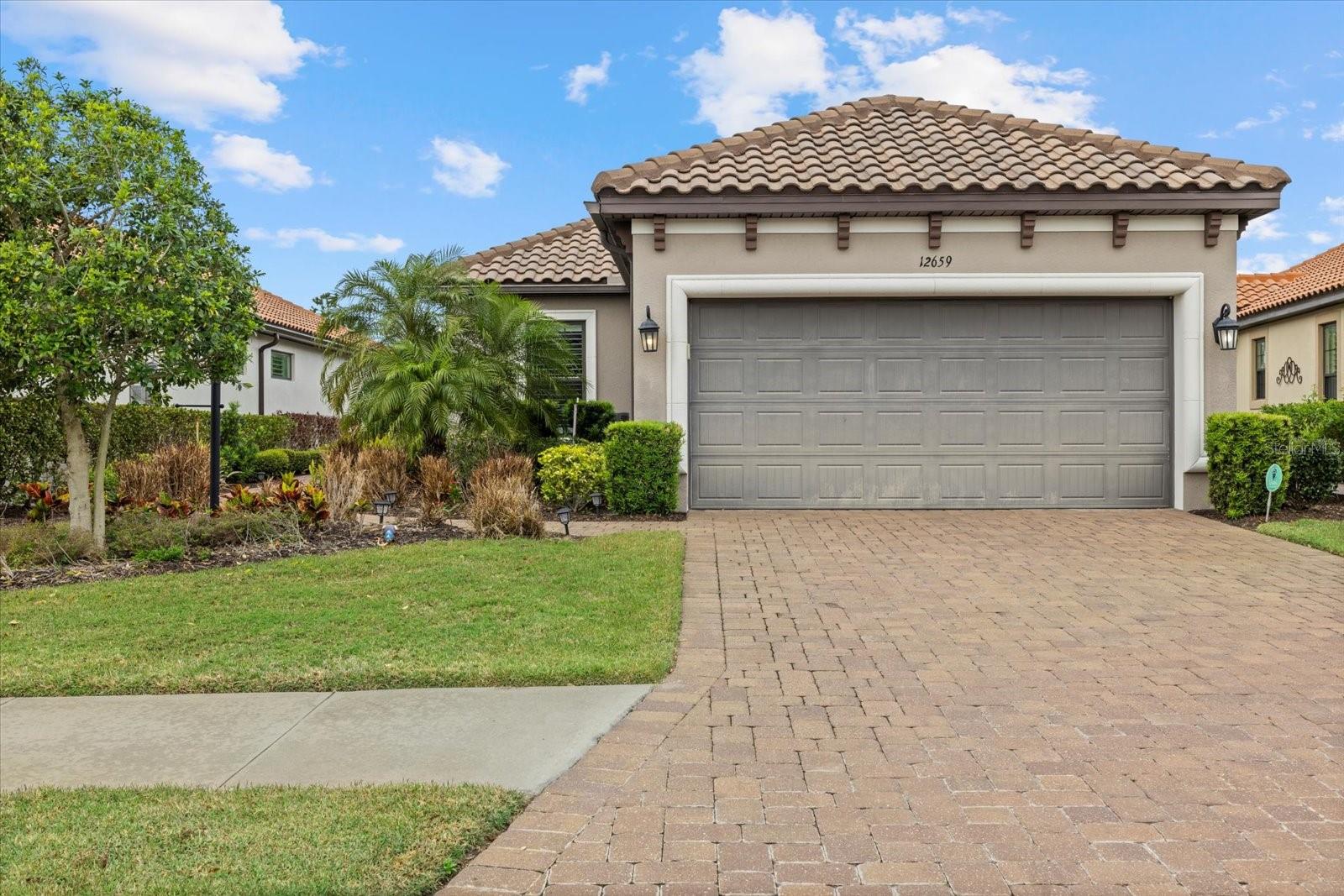 One or more photo(s) has been virtually staged. The GOLF-DEEDED home you’ve been waiting for is here! Welcome to Esplanade Golf & Country Club, where every day feels like a vacation. This charming Roma model offers a thoughtfully designed floor plan featuring two bedrooms, two bathrooms, a formal dining room, and a versatile den—perfect for an office or bonus room. Elegant tray ceilings, crown molding, and plantation shutters add timeless character throughout the home. The chef’s kitchen is beautifully appointed with quartz countertops, GE stainless steel appliances, and a stylish backsplash, making it both functional and stunning. Step outside to your expansive covered lanai, ideal for outdoor dining and entertaining. The clear-view screen enhances the view of the lush, mature landscaping, while the outdoor kitchen—complete with a granite countertop, grill, mini fridge, sink, and ample storage—makes hosting effortless. Plus, a motorized hurricane wind screen provides both privacy and peace of mind. The owner’s suite boasts a dual vanity, spacious walk-in closet with custom organization. Additional upgrades include a tankless water heater, reverse osmosis system in the kitchen, and hurricane shutters, ensuring convenience, efficiency, and security. With just a fresh coat of paint and new carpeting, this home will feel like a brand-new space! Esplanade Golf & Country Club offers endless opportunities for fitness and social engagement. Residents enjoy a wealth of amenities, including an 18-hole championship golf course, two resort-style pools, hot tubs, a resistance pool, pickleball, tennis, bocce ball, two fitness centers, exercise classes, two dog parks, a playground, a firepit, a spa/salon, and a Tiki bar. An on-site lifestyle director organizes social events, clubs, and activities. The state-of-the-art Culinary Center provides multiple dining options, including the Barrel House, as well as catering services, wine tastings, and special events. Conveniently located in the heart of Lakewood Ranch, Esplanade offers easy access to I-75, Lakewood Ranch Main Street, University Town Center, Sarasota Polo Club, shopping, dining, entertainment, hospitals, cultural attractions, boating, parks, and Florida’s renowned sandy beaches.