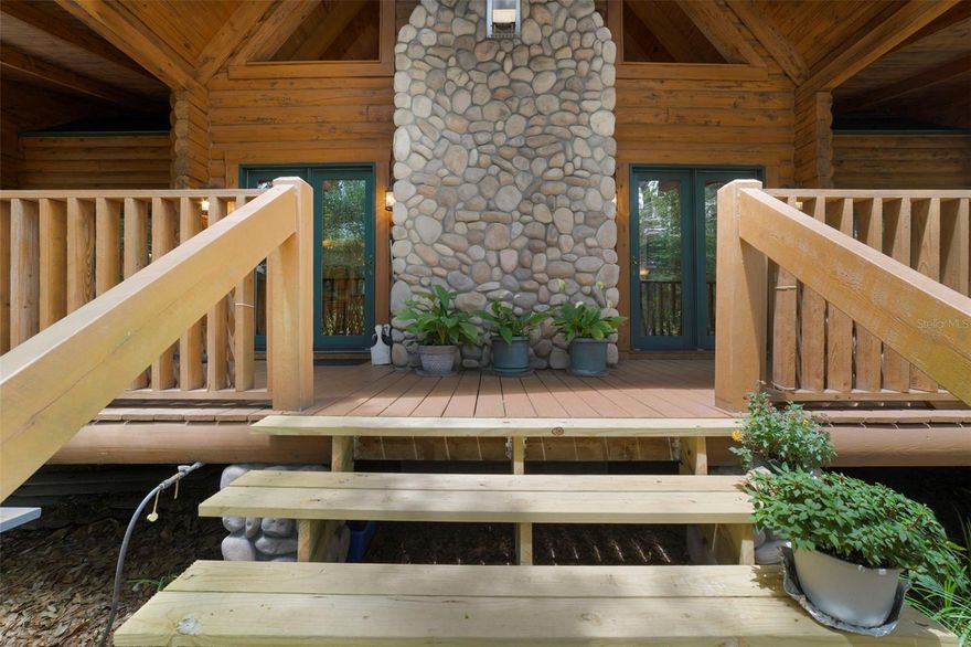Tucked beneath the trees on a rare 1.4-acre homesite with DEEDED access to a private ski LAKE! An irreplaceable handcrafted cypress lodge estate, where mountain luxury meets the heart of Sanford Fl. Using traditional techniques, yet thoughtfully planned for Florida conditions. From the moment you arrive, the home feels more like a private Smoky Mountain retreat than a Florida residence, blending lodge-style craftsmanship with the convenience of being just minutes from charming downtown Sanford. Constructed with authentic 6-inch cypress logs using saddle-notch construction and lag screw fastening approximately every 18 inches, this remarkable home showcases an incredible level of craftsmanship and structural detail rarely found in today’s construction. Elevated stem wall and support pier foundation construction, soaring timber-framed ceilings, expansive covered porches, and substantial custom masonry detailing create a level of architectural character that is extraordinarily difficult and costly to reproduce. Inside, the dramatic great room immediately captures attention with soaring vaulted ceilings, exposed beams, spectacular floor-to-ceiling stone fireplace, and warm wood finishes throughout. Expansive DOUBLE PANE windows & multiple French doors flood the home with natural light while seamlessly connecting the interior spaces to the sprawling covered porches & peaceful wooded surroundings. The spacious kitchen overlooks the main gathering areas & offers abundant cabinetry, breakfast bar seating, stainless steel appliances, & the open-concept design perfectly suited for entertaining. Rich 3/4-inch tongue-and-groove red oak flooring flows throughout much of the home, complementing the natural warmth and timeless appeal of the custom construction. The primary suite offers a peaceful retreat atmosphere with direct porch access & serene natural views. Upstairs, a beautiful open catwalk overlooks the breathtaking great room below & leads to two extremely generous guest bedrooms and a full bath, creating the perfect setup for guests, home offices, hobby spaces, or private retreats. The upstairs bedrooms also feature additional storage areas, & throughout the home you will find an absolutely incredible amount of closet/storage rarely found in homes of any style. Additional features include 2021 ROOF, DOUBLE-PANE windows & doors, CENTRAL VAC, GAS heat, gas appliances, outdoor gas grill connection, tankless water heater, irrigation system, security system & 2.5 GARAGE, WORKSHOP SPACE, FLOORED ATTIC. Outside, the setting is equally special. MASSIVE covered porches FRONT & BACK invite morning coffee, evening gatherings, & year-round enjoyment of the private surroundings. With NO HOA, there is ample room for boats, RVs, recreational toys, workshops, & future possibilities. The property also includes dedicated access to a private ski lake, offering an incredibly rare lifestyle opportunity!  This gorgeousness is located just minutes from charming brick-paved Downtown Sanford filled with historic buildings, incredible dining, boutiques, festivals, live entertainment, & endless local charm. Ride your golf cart to Downtown Sanford and enjoy sunsets along Lake Monroe, waterfront parks, shopping, world-class breweries, and amazing dining.  Excellent location with quick access to the 417, shopping, dining, and close proximity to Sanford International Airport, Lake Mary/Oviedo/Orlando. This gorgeous home is truly a one-of-a-kind gem!!