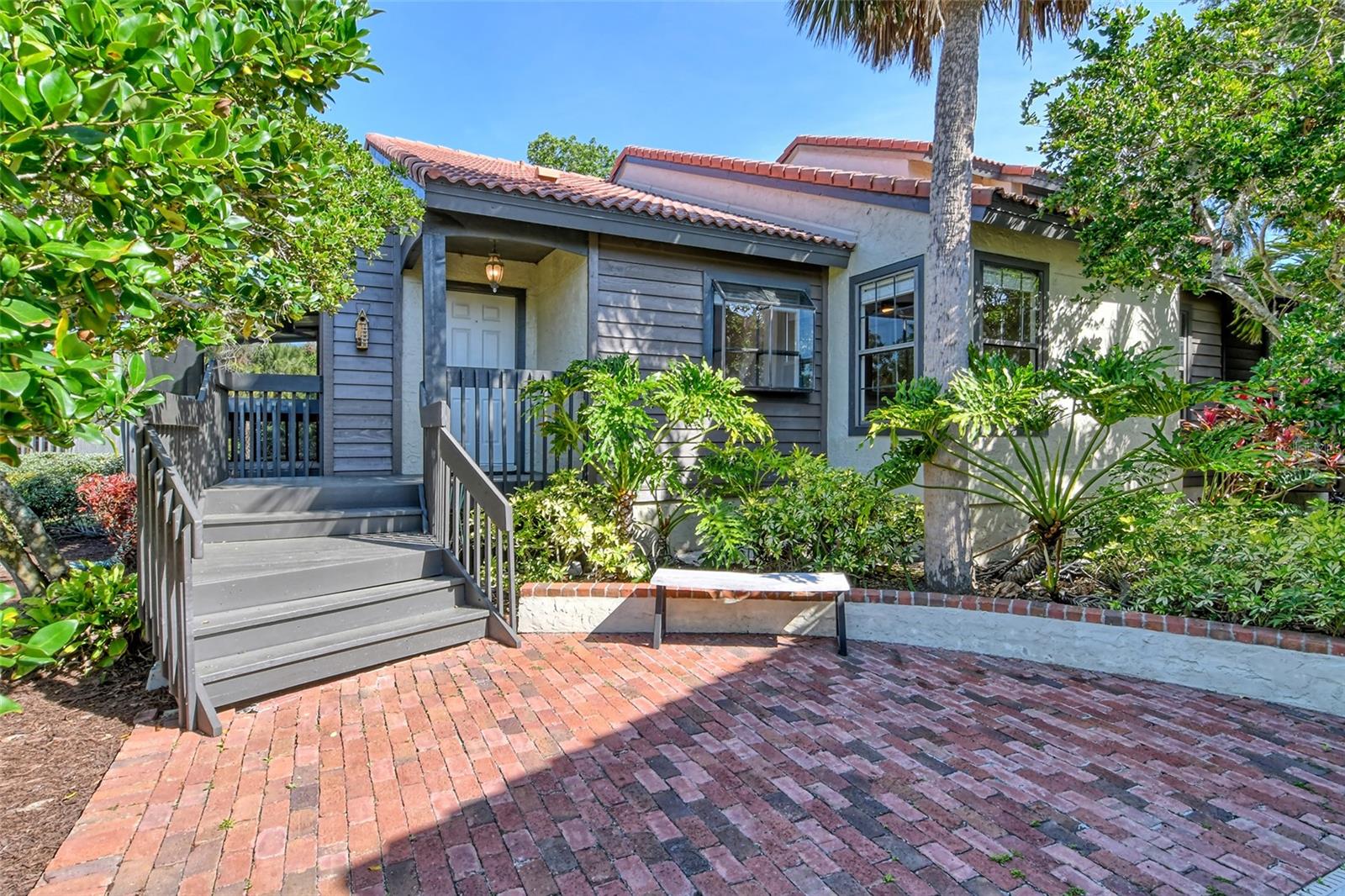One or more photo(s) has been virtually staged. Looking for a villa with a Garage Plus Carport close to Downtown Sarasota? You will be charmed with the mature natural beauty surrounding you with a central lake, walking paths and you are located very close to the Legacy Trail, connecting Sarasota to Downtown Venice. Secluded clusters of natural, maintenance-free Villas provide affordability, serenity and community enhancements. This Villa has its own enclosed garage, covered carport plus additional space for parking. The Lakes boasts mature landscaping and a serene atmosphere conveniently located minutes to downtown Sarasota, the Beaches, Shopping and all major roadways. This completely updated Villa features an Open Floor Plan with vaulted ceilings, plenty of windows and offers two separate large screened porches, one off the great room and one off the primary bedroom! The spacious kitchen with light cabinets, new countertops and stainless steel appliances includes plenty of floor space for a table and chairs or room for an island plus there’s a breakfast bar with open access to the Great Room and greenhouse window for your plants or herb gardens. The kitchen drawers and cabinet doors are soft close and all cabinets have pull-out shelves! The primary bath has dual sinks, the second bath has a large vessel sink and there are dual large sinks in the kitchen. The two bedroom layout is a split plan with the welcoming, updated hallway bath being adjacent to the second bedroom. The Primary Bedroom boasts vaulted ceilings, a remodeled ensuite bathroom with separate shower and two large closets. The surprise is the enclosed porch off of the Primary Bedroom, allowing privacy and relaxation. The second large enclosed porch is located off of the vaulted ceiling Great Room, adding to the total square footage. You will be pleasantly greeted by luxury vinyl flooring throughout this Villa, giving a wonderful flow between rooms. Additional features are the stack washer and dryer, new water heater and a nearly new central air system. The attractive built-in shelving in the great room will highlight your entertainment system, library or a prominent display area for your collectibles. The affordable monthly fee covers exterior grounds maintenance, common area insurance, recreation facilities, 2 pools, one heated one not heated, tennis courts, basketball court, clubhouse and fitness center. Welcome to your new home!