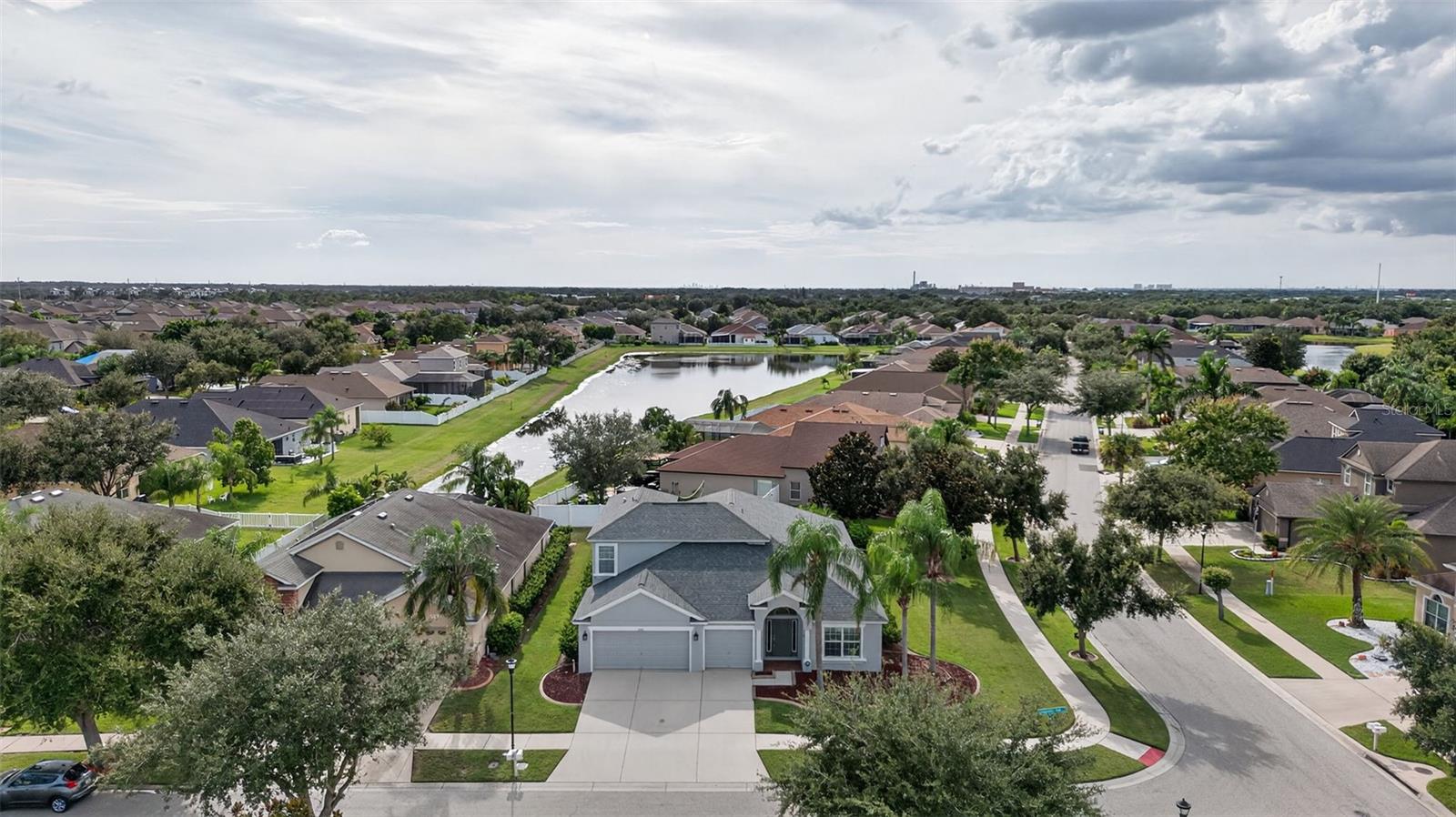 CHECK THIS OUT!! One of the Best Streets in South Fork! ~ This beautifully designed home offers the perfect combination of space, comfort, and flexibility. With 5 BEDROOMS, 4 FULL BATHROOMS, and a PRIVATE OFFICE (or a 6th Bedroom if you add a wardrobe), the floor plan is ideal for large families, guests, or MULTI-GENERATIONAL LIVING ~ Four bedrooms and the office are conveniently located on the MAIN FLOOR ~ while UPSTAIRS you’ll find a versatile BONUS ROOM with POOL TABLE, and EXTRA LIVING SPACE FOR Comfortable SEATING to watch TV or MOVIES ~ And another BEDROOM AND FULL BATHROOM ~ There is even a LARGE STORAGE CLOSET making it the perfect spot for a playroom, media room, or private guest suite ~ The thoughtful four-way split design provides privacy for everyone while still offering inviting spaces to gather ~ Separate FORMAL LIVING, DINING, and FAMILY ROOMS create multiple options for entertaining, while FRENCH DOORS open to the FIRST FLOOR OFFICE for a quiet, light-filled workspace ~ At the heart of the home, the gourmet kitchen features tall wood cabinetry, GRANITE countertops, and plenty of prep and storage space ~ The spacious primary suite offers a walk-in closet, dual vanities, a roman soaking tub, and a separate shower ~ Just beyond, the OVERSIZED screened and covered pavered LANAI provides a welcoming setting for outdoor dining or relaxation ~ There is plenty of room for an OUTDOOR LIVING ROOM AND OUTSIDE DINING ~ One of the standout features of this home is the 3 CAR GARAGE paired with the WIDE DRIVEWAY ~ Don’t you hate it when you see a beautiful, spacious home with barely enough room to park? That’s not the case here—this property offers generous parking and storage, perfect for families with multiple vehicles, or guests ~ This home has also been carefully maintained with major updates already complete ~ A NEW ROOF was installed in AUGUST 2025, the downstairs AC SYSTEM was replaced in 2023, the water heater is only four to five years old, and most of the interior was freshly painted in August 2025 and the EXTERIOR was PAINTED IS 2023 ~ To make it even better, the HOME COMES WITH A POOL TABLE AND ACCESSORIES, ready for family fun and entertaining ~ Lots of Community amenities including a cabana pool area, playground, volleyball, basketball, tennis courts, and a dog park ~ With easy access to US-301 and I-75, shopping, dining, and entertainment are just minutes away, and commuting to Tampa, MacDill AFB, or Bradenton is a breeze.