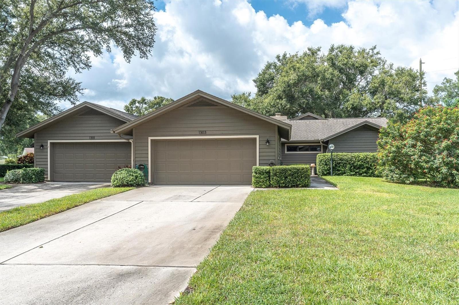 One or more photo(s) has been virtually staged. Welcome to Westlake Villas in Palm Harbor! This 2BR plus office/den, 2BA, 2 car garage villa combines comfort and convenience in a prime location. Seller offering $5,000 toward new flooring with full asking price, make it your own! Features include a bay window breakfast nook, formal dining area, and sunken living room with stone fireplace. The primary suite boasts vaulted beamed ceilings, walk-in closet, and ensuite bath with dual sinks & walk-in shower. A guest bedroom and full bath provide comfort for visitors. Enjoy Florida living on the two-level patio overlooking serene oaks and manicured grounds. HOA includes internet, roof, exterior paint, lawn care, pest control, water, sewer & trash. Just minutes from shopping, dining, Old Palm Harbor, and Gulf beaches. Distinctive villa, sought-after community. Several of the photos have been staged-see it today!