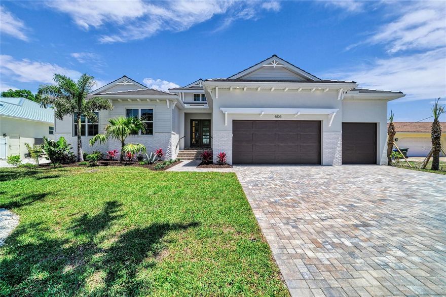 Completed new construction! Built safely and securely ten feet above the island’s flood plain, 5103 Windward is unparalleled new construction with saltwater boating access to the Intracoastal Waterway and Gulf beyond. Along the water’s edge, this homesite spans nearly 1/3 acre on the Grand Canal with 90 ft. of new seawall. The central Siesta Key location makes getting to the spectacular white sand beaches and charming Siesta Village easy and convenient. The free-flowing plan, offering 3,034 sq. ft. of open living, will seduce you with its inviting atmosphere wrapped in casual elegance and modern sophistication. With plenty of natural light, the great room boasts double-height ceilings adorned with rich architectural detail, an elaborate floor-to-ceiling fireplace wall, and see-through views to the expansive outdoor space and coveted canal setting. Beyond the great room’s glass doors, an entertaining lounge with wood ceiling accents, a professional grill station, and a heated pool/spa await your plans for spending cherished time with family and friends. As evening approaches, night lighting transforms the beautiful backyard and creates a timeless ambiance that encourages relaxation and reflection. A gorgeous kitchen is enhanced with an abundance of amenities including a premium Sub-Zero and Wolf appliance package, stone counters, stylized fixtures and finishes, a walk-in pantry, and adjoining laundry. The formal dining room features a built-in buffet and French doors leading to a brick paver patio, making it a wonderful spot for dining alfresco under the stars. The bonus room, with wet bar and pool bath, features two walls of glass sliders showcasing the extensive outdoors and picturesque water views. The primary suite is an oasis of serenity with an office outfitted with built-ins, a generous wardrobe for two, and an exquisite bath intended to pamper and spoil with a free-standing tub, a frameless glass shower with rain head, separate vanities with stone tops, and a water closet. Two additional en-suites offer plenty of room to unwind and rejuvenate in comfortable privacy. A brick paver drive, a 3-car garage, professional landscaping with timed irrigation, eye-catching curb appeal, and other notable customizations inside and out, complete this magnificent waterfront home. This fresh new residence, designed by the award-winning team at Allegra Homes, has been artfully designed and crafted to offer the highest quality to those who live here. An exciting opportunity to make this island paradise yours!