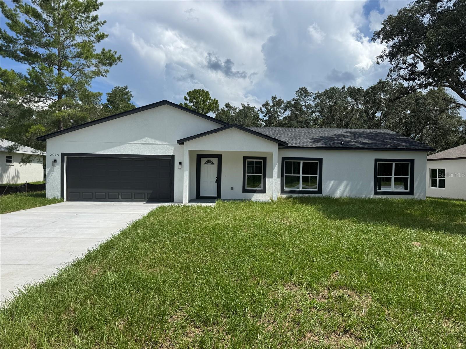 READY TO MOVE IN! ASSISTANT WITH CLOSING COST , 1 YEAR HOME WARRANTY, AND INTEREST RATE DISCOUNT POINTS ARE AVAILABLE WITH PREFERRED LENDER
Stunning New Construction –3Bed,2 Bath Home in Citrus Springs! This exquisite 1,856 sq. ft. brand-new 3 bedroom, 2 bathroom home offers a perfect blend of modern elegance and functional design. The open-concept floor plan is filled with natural light, creating a warm and inviting atmosphere. The gourmet kitchen boasts countertops, sleek ceiling-height white cabinetry, stainless steel appliances, and a spacious island—ideal for both cooking and entertaining. Throughout the home, luxury vinyl plank flooring and tile provides a seamless, low-maintenance look—no carpet anywhere! Expansive double sliding doors lead to a private backyard, offering plenty of space for outdoor relaxation, gatherings, or even future customization. A charming front balcony area adds to the home’s curb appeal, while the double-car garage provides ample storage and parking. Located in the highly desirable Citrus Springs community, this home comes with no HOA restrictions, giving you the freedom to enjoy your property as you see fit. Conveniently situated near local springs, shopping, dining, and outdoor recreation, this is the perfect place to call home. Don’t miss this incredible opportunity—schedule your private tour today!