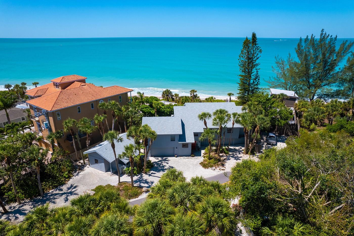 Gulf-front serenity on Casey Key. On the desirable shores of Casey Key, this quintessential beachfront retreat, Osmyrrah, is a sanctuary of tranquility, designed for relaxed, organic living with an intimate connection to the sea. With private, pristine beachfront and panoramic Gulf views, you’ll be immersed in dazzling sunsets, soft white sands and the soothing rhythm of the waves every single day. Savor nature’s splendor in nearly 3,000 square feet of elevated living space, where an open-concept layout, soaring ceilings and walls of glass bring the outside in. The expansive great room and dining area seamlessly flow into a generous kitchen with panoramic Gulf views, ideal for entertaining or pensive mornings. Go onto the open deck for grilling and sunning or unwind on the large screened-in porch while warm breezes and golden skies set the mood. The gulf-front primary suite is a private oasis with lofty ceilings, stunning water views, a luxurious renovated bath and a spacious walk-in closet. A guest bedroom, full bath and dedicated office complete the north wing. On the south side, you’ll find a second large primary suite with its bath and walk-in closet, along with a full laundry room. Guests will delight in their own charming 360-square-foot guest house, complete with a private entrance, high ceilings, living area and full bath, near the beach and a refreshing outdoor shower. Additional highlights include a two-car garage, new HVAC (2025), roof (2019) and an expansive under-home storage area, ideal for kayaks, paddleboards and all your coastal toys. A private walkway leads to your beachfront deck and down to the sand, offering an experience akin to a Caribbean island escape. The property also includes a three-foot deeded bay access easement and a reciprocal beach access easement for the bayside neighbor. On this serene 8-mile barrier island of fewer than 400 homes, you’ll enjoy rare privacy, natural beauty and Gulf ownership to the mean high-water line. South of the iconic Blackburn Point swing bridge, you’re just minutes from golf, dining, shopping, top-rated schools - including nationally acclaimed Pine View School - and vibrant cultural destinations in Sarasota and Venice. If you’ve dreamed of living where sunsets paint the sky, dolphins dance at dawn and every day ends with your toes in the sand, Osmyrrah awaits.