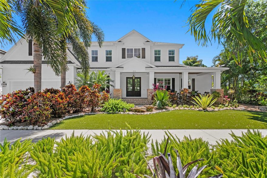 On an expansive, .24-acre beautifully landscaped lot, this stunning urban farmhouse by Brookshire Homes offers a blend of luxury, functionality and charm. From the moment you arrive, the inviting brick-paved front porch sets the tone for the warmth and elegance that awaits inside. Step into the heart of the home, an entertainer’s dream chef’s kitchen, complete with top-of-the-line Thermador stainless steel appliances, marble countertops, an oversized island, and custom 42-inch wood cabinetry. A hidden pantry provides exceptional storage, while the open-concept design seamlessly connects the kitchen to the spacious family room and informal dining space. A sleek indoor/outdoor fireplace adds a touch of sophistication, and French doors lead out to the serene backyard retreat. The thoughtfully designed floor plan includes a butler’s pantry linking the kitchen to the formal dining room, a private office overlooking the front porch, and a well-appointed mudroom off the garage. A versatile fifth bedroom with a walk-in closet and en-suite bath is ideal for guests or can be combined with the bonus room to create an incredible in-law suite. Upstairs, the luxurious primary suite offers a spacious bedroom, oversized walk-in closet, and a spa-like en-suite bath featuring a freestanding tub, separate shower and elegant marble flooring. A private sitting area in the suite provides a space for a second office, yoga nook or cozy reading retreat. Three additional bedrooms, each with walk-in closets, two additional baths, and a generously sized laundry room complete the upper level. Outside, your private oasis awaits. The covered back porch, adorned with wood-planked ceilings, overlooks a sparkling pool, spa and lush yard space. The outdoor kitchen is ready for alfresco dining and entertaining. For outdoor enthusiasts and car lovers alike, the oversized garage with tandem parking on one side offers ample space for a boat, jet skis, golf cart, bikes or whatever your passion requires. Overhead storage racks maximize organization and functionality. In a sought-after South Tampa neighborhood, this home offers privacy and convenience, with open green spaces and easy access to top-rated schools, dining and entertainment.