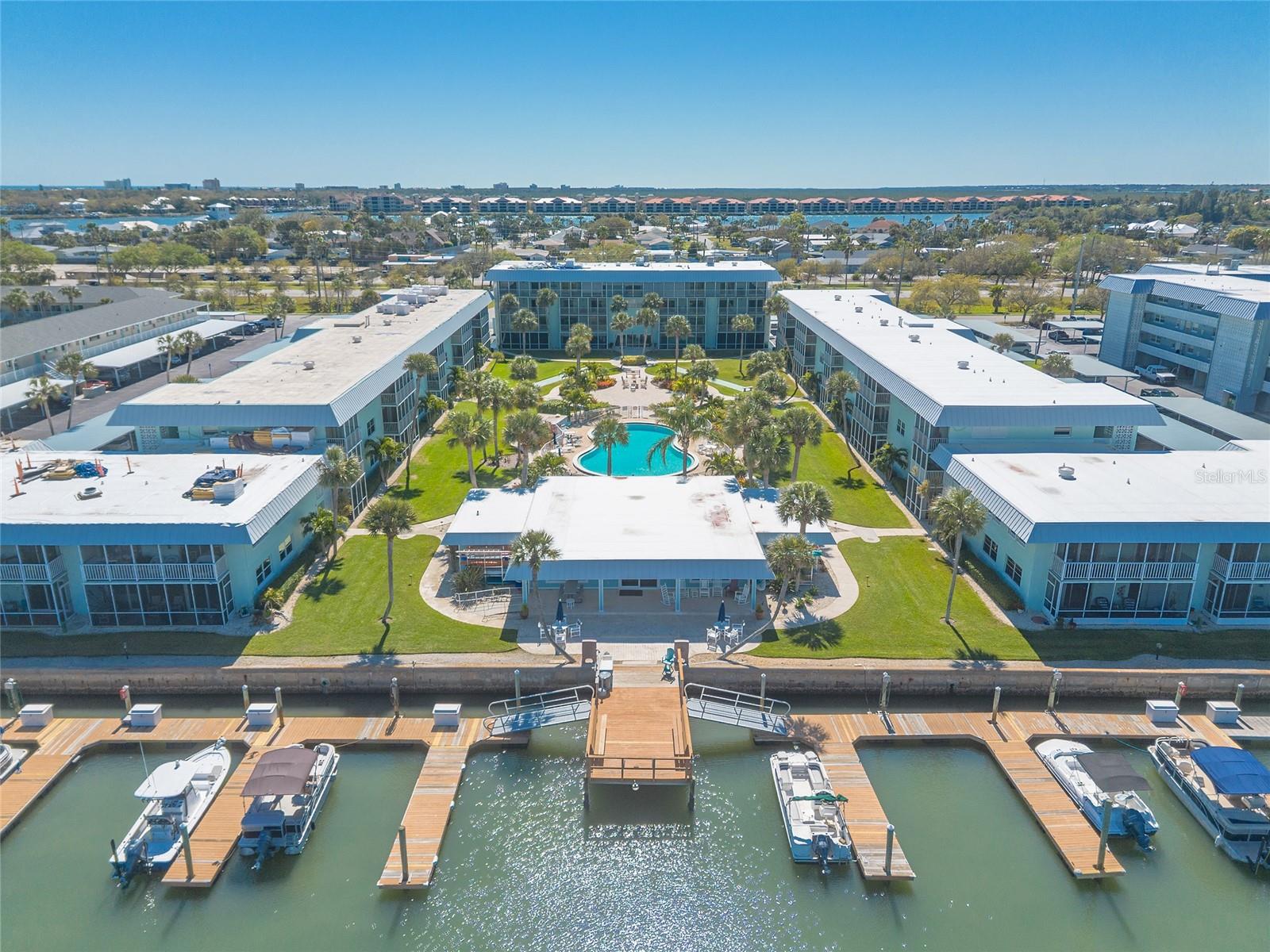 Completely renovated 1st floor condo in New Smyrna beach. No expense was spared! The moment you enter this light filled unit you will immediately notice the porcelain tile floor, stunning wood ceilings and recessed lighting. The kitchen boasts top-of-the-line Kraftsmaid cabinets with built-in's and pull outs on nearly every door and drawer. High end Cafe appliances, farmhouse sink and quartz countertops make cooking and entertaining a treat. Both bathrooms have been remodeled with modern fixtures, luxury finishes, and a coastal contemporary design. Custom plantation shutters offer privacy and an abundance of natural light. Enjoy the coastal breezes on the tiled screened porch that overlooks the courtyard with access from the living area and bedroom. Live like you're on vacation every day! Just minutes to Flagler avenue for shopping and dining. And of course the beach. Furniture is available for purchase. Waterway East Condos offers a pool, clubhouse, fishing dock, and boat slips. HOA fees include water, sewer, cable, internet, trash, monthly pest control and maintenance.