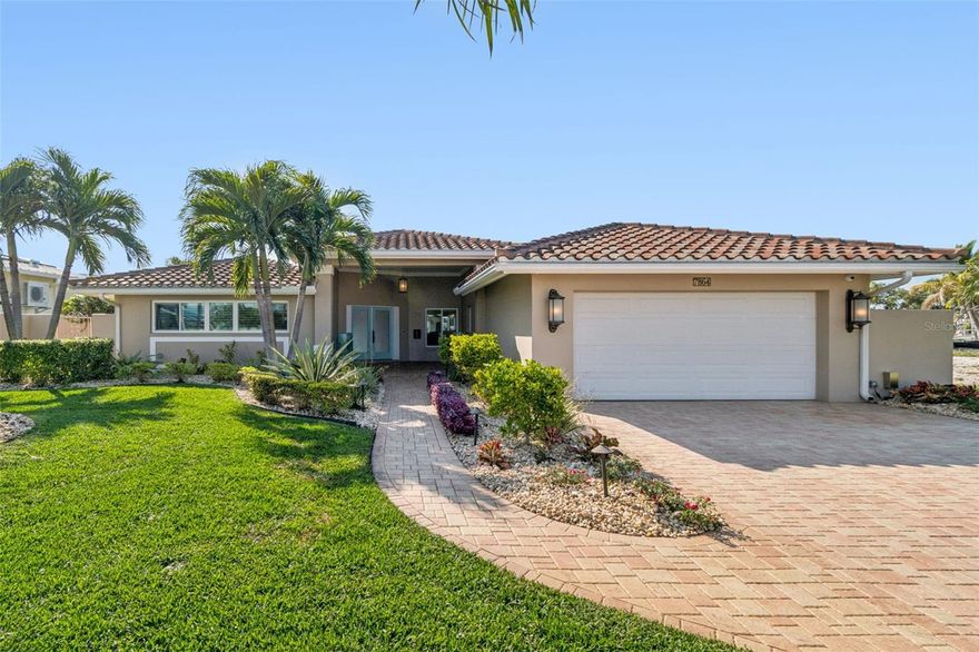 One or more photo(s) has been virtually staged.  An exceptional waterfront offering in the coveted Yacht Club Estates of St. Petersburg, this fully remodeled coastal residence defines refined Florida living. Encompassing 3 bedrooms and 2 bathrooms, the home boasts 70 feet of deep-water frontage with direct access to the Gulf and no fixed bridges, offering a seamless boating lifestyle.  A private dock with a 13,000 lb boat lift invites effortless cruising to Egmont Key, Shell Key, and celebrated waterfront destinations. Interiors are thoughtfully designed with open-concept living, elevated finishes, and an effortless indoor-outdoor flow. Outdoors, a resort-style pool and spa, travertine terrace, covered lanai, and professionally curated landscaping create a private sanctuary ideal for both entertaining and everyday luxury.  A paver drive and 2-car garage complete the home’s elegant arrival. Ideally positioned just minutes from Treasure Island’s white-sand beaches and the cultural, culinary, and nightlife offerings of downtown St. Pete, this residence delivers a rare combination of sophistication, privacy, and premier waterfront access.