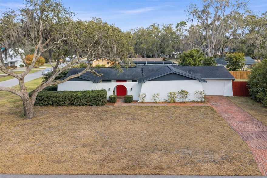 Welcome to your private country-style retreat — perfectly positioned on a large corner lot in a quiet cul-de-sac, yet just minutes from USF, downtown Tampa, major highways, and Nye Park. Zoned for A-rated elementary and middle schools, this beautifully updated 3-bedroom, 2-bath home offers the ideal blend of charm, character, and convenience — with NO HOA and no flood insurance required.

From the moment you enter through the solid wood double doors, you’ll notice the light-filled interior and distinctive architectural touches, including arched doorways, crown moulding throughout, and beautiful laminate flooring. The spacious living room flows seamlessly into the dining area and kitchen, creating an inviting layout for everyday living and entertaining.

The kitchen features solid wood cabinetry, stainless steel appliances, and a generous walk-in pantry area. Updated bathrooms add modern style and comfort, while energy-efficient windows enhance both beauty and functionality.

A large sunroom — included in the heated square footage (Buyer responsible for verifying all measurements) provides exceptional flexibility as a bonus space, family room, or entertaining area with views of the backyard oasis. The primary suite offers a peaceful retreat with French doors and a soothing atmosphere.

Step outside to your spectacular screened pool and spa, where the expansive lanai creates a true private getaway. Mature landscaping, nearby lakes, and the oversized corner lot give the property a serene country feel. The backyard also includes two storage sheds and a Culligan water softener system for added convenience.

With its mid-century modern vibe, unique design elements, and move-in ready condition, this home is truly one of a kind — offering space, style, and a location that keeps you close to everything while feeling worlds away.