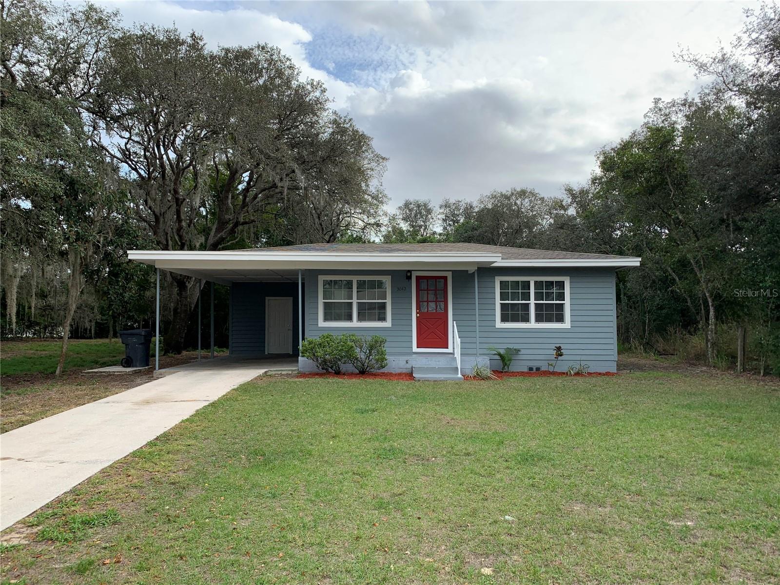 Home recently remodeled with hard surface floors, covered carport, large yard close to shopping and park.